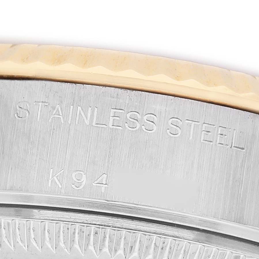 The image shows a close-up of the edge and part of the bezel of a Rolex Datejust 79173 Women's Steel and Gold (two tone) Silver Dial, highlighting the "STAINLESS STEEL" engraving.