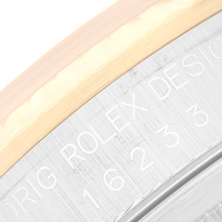 This close-up image shows the edge and engraving on the case back of a Rolex Datejust 16233 Men's Steel and Gold (two tone) White Dial 16233 Men's Steel and Gold (two tone) White Dial watch.