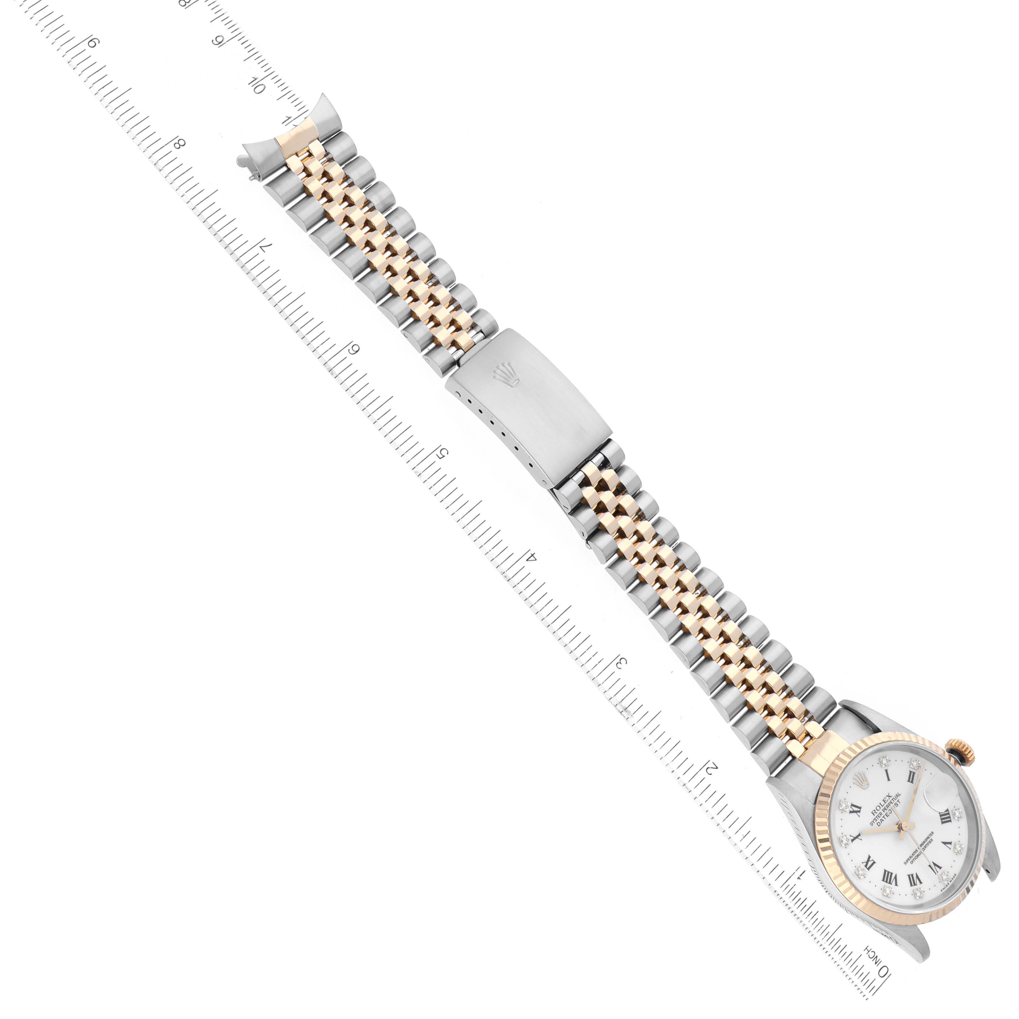 The image shows a Rolex Datejust 16233 Men's Steel and Gold (two tone) White Dial 16233 Men's Steel and Gold (two tone) White Dial watch laid flat, displaying its bracelet, clasp, and face lying alongside a ruler.