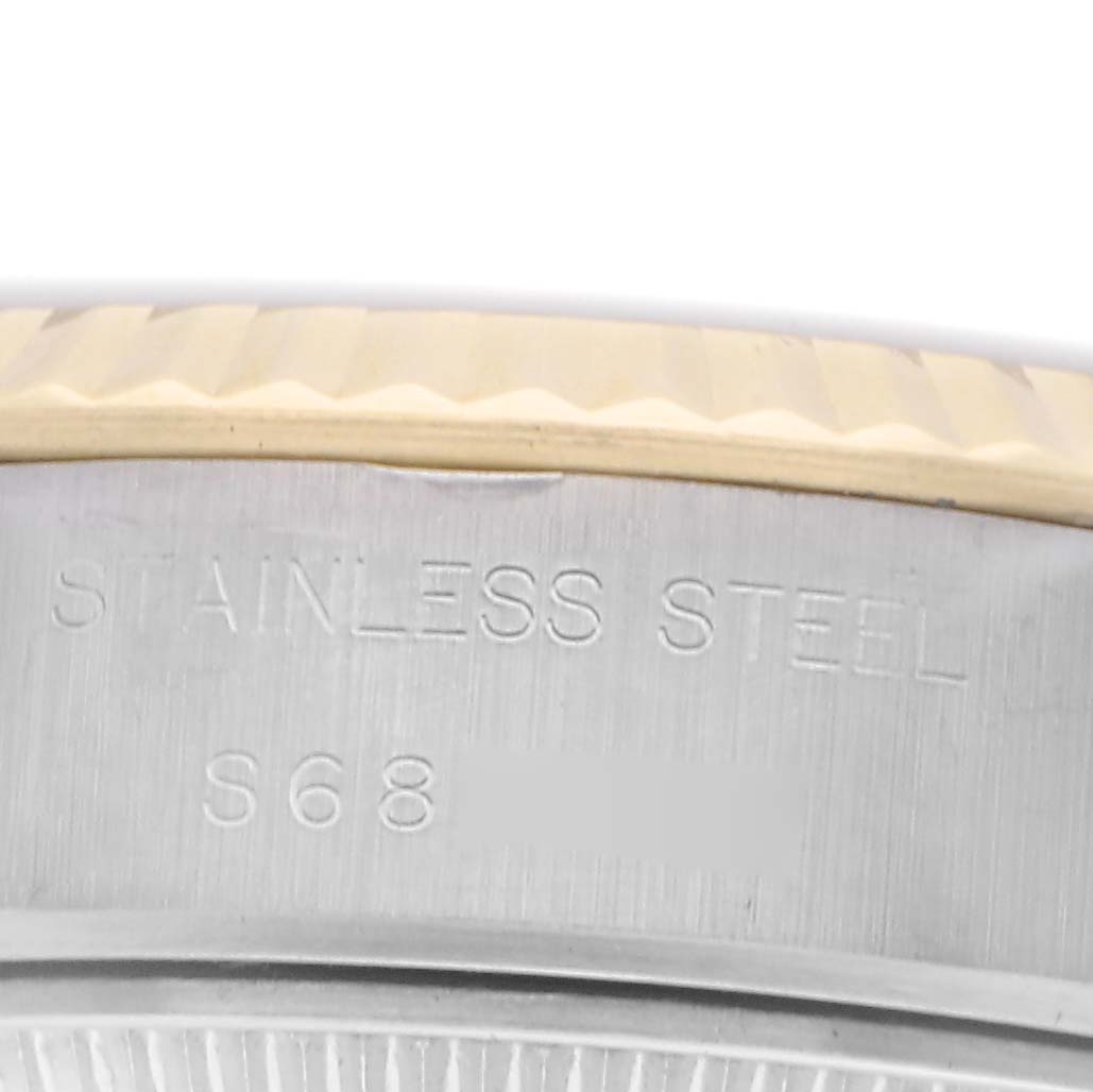 The image shows a close-up of the case edge and bezel of a Rolex Datejust 69173 Women's Steel and Gold (two tone) White Dial 69173 Women's Steel and Gold (two tone) White Dial, highlighting "STAINLESS STEEL" engraving.