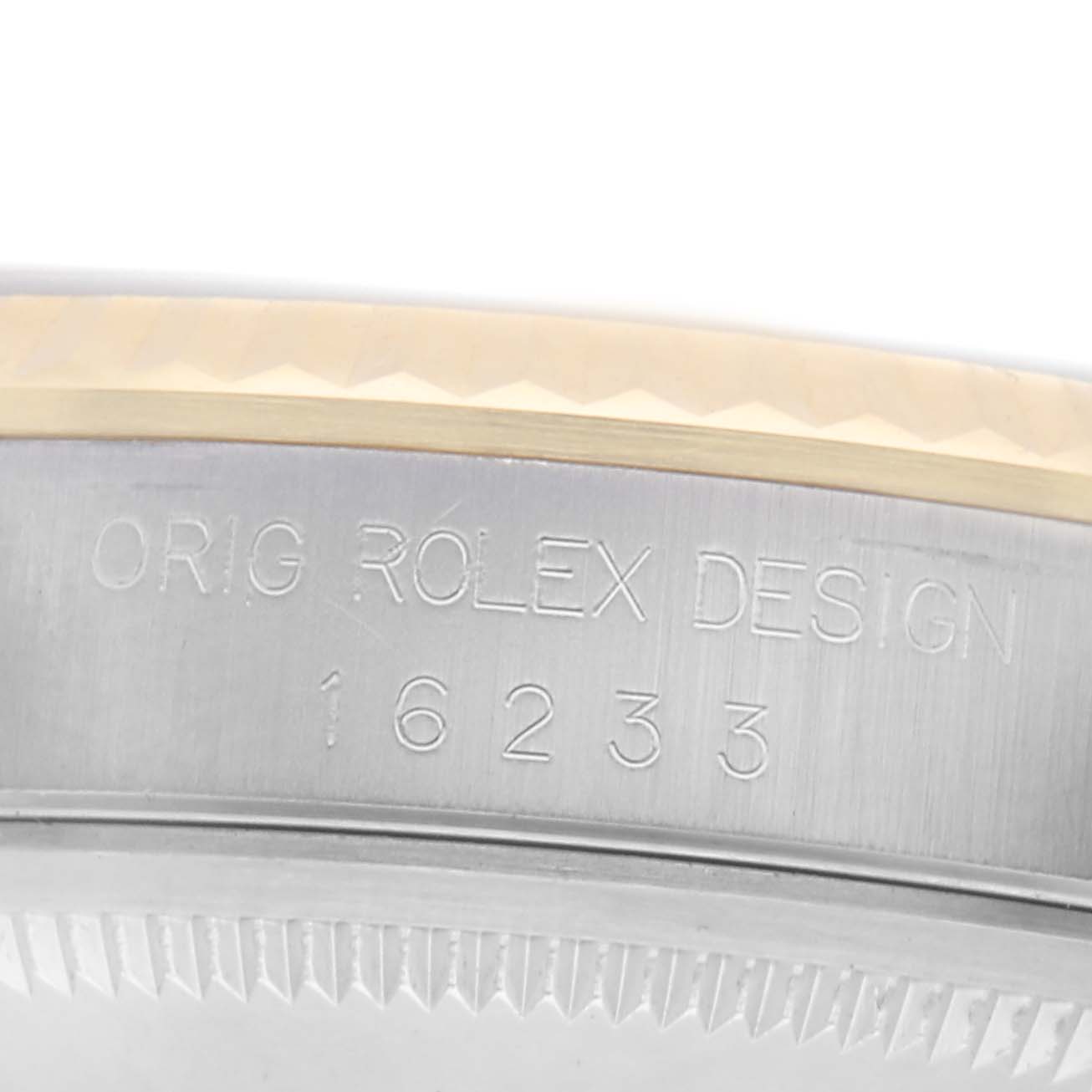 The image shows a close-up of the side of a Rolex Datejust 16233 Men
s Steel and Gold (two tone) White Dial 16233 Men
s Steel and Gold (two tone) White Dial watch, highlighting the engraved model and design numbers on the case.