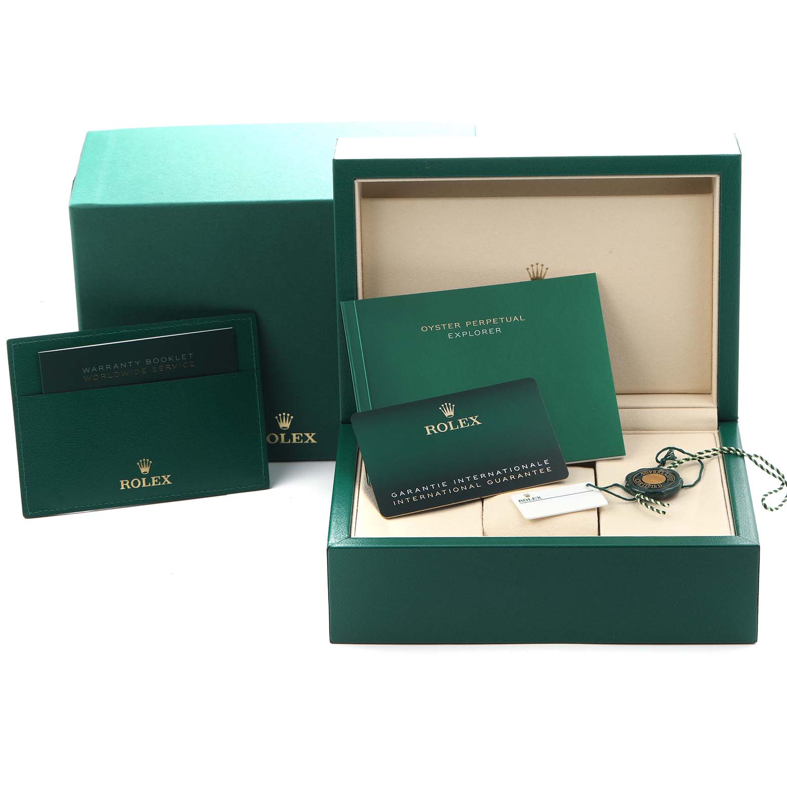 The image shows the packaging and accessories for a Rolex Explorer 124270 Men
s Stainless Steel Black Dial 124270 Men
s Stainless Steel Black Dial, including boxes, manuals, a warranty card, and a tag.