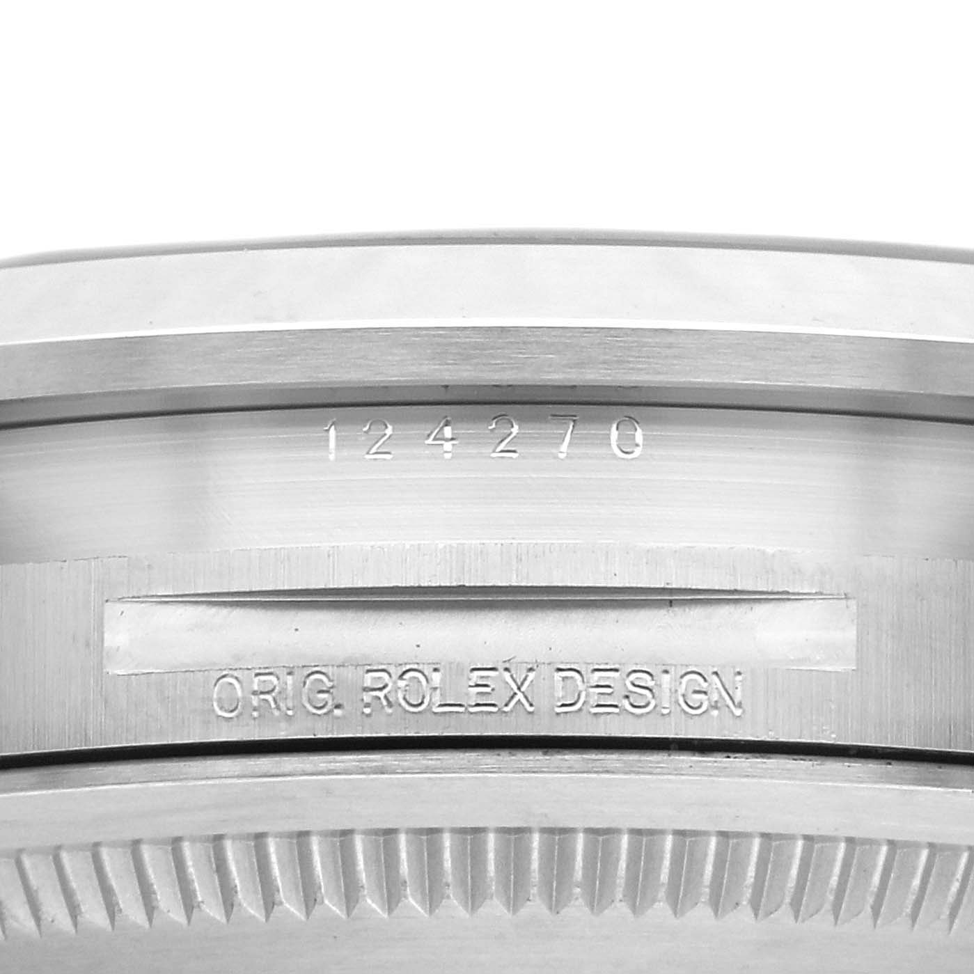 The image shows the side view of a Rolex Explorer 124270 Men
s Stainless Steel Black Dial 124270 Men
s Stainless Steel Black Dial, focusing on the engraved reference number and "ORIG. ROLEX DESIGN."