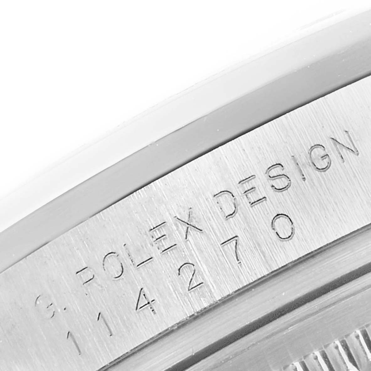 This is a close-up image showing the engraved text on the case side of a Rolex Explorer 114270 Men's Stainless Steel Black Dial 114270 Men's Stainless Steel Black Dial watch.