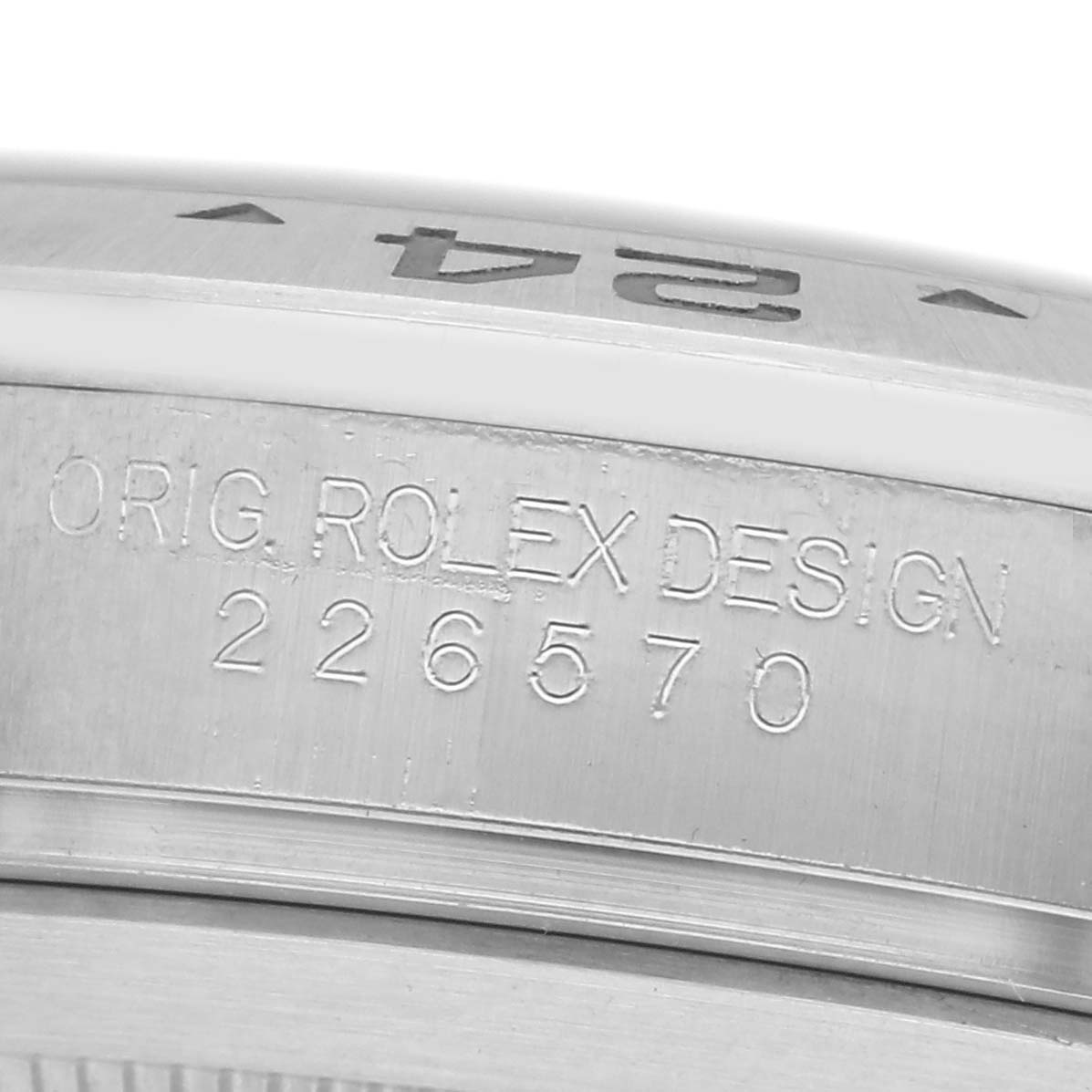 The image shows a close-up of the Rolex Explorer 226570 Men
s Stainless Steel Black Dial 226570 Men
s Stainless Steel Black Dial model 226570
s case side, highlighting the engraved design details.