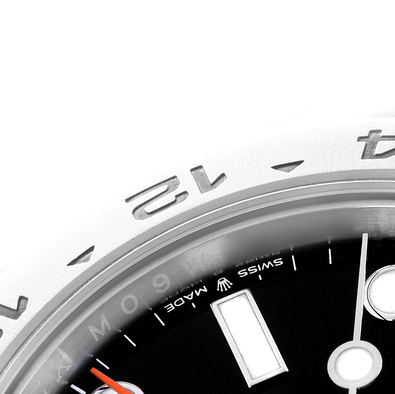 The image shows a detailed close-up of the Rolex Explorer 226570 Men
s Stainless Steel Black Dial 226570 Men
s Stainless Steel Black Dial watch
s bezel and part of the dial with markers.