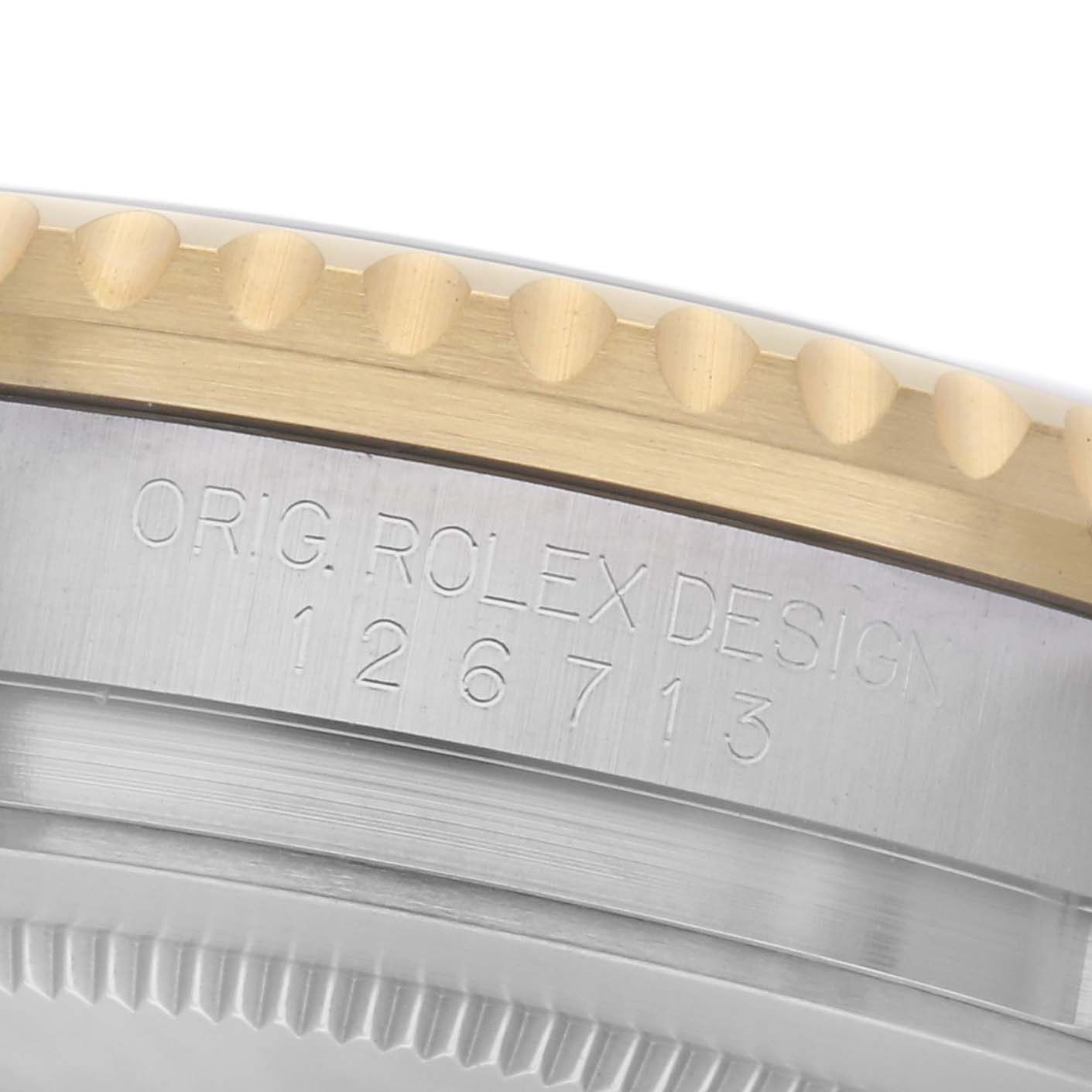 The image shows a side view of the Rolex GMT-Master 126713GRNR Men
s Steel and Gold (two tone) Black Dial 126713GRNR Men
s Steel and Gold (two tone) Black Dial
s bezel, focusing on the engraved model number.