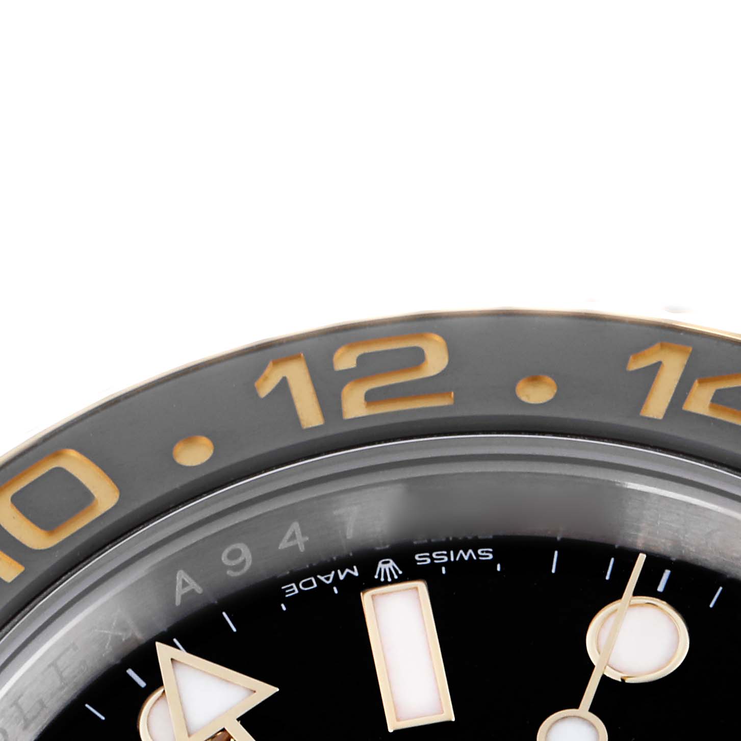 The image shows a close-up of the bezel and part of the dial of a Rolex GMT-Master 126713GRNR Men
s Steel and Gold (two tone) Black Dial 126713GRNR Men
s Steel and Gold (two tone) Black Dial, focusing on hour indicators.