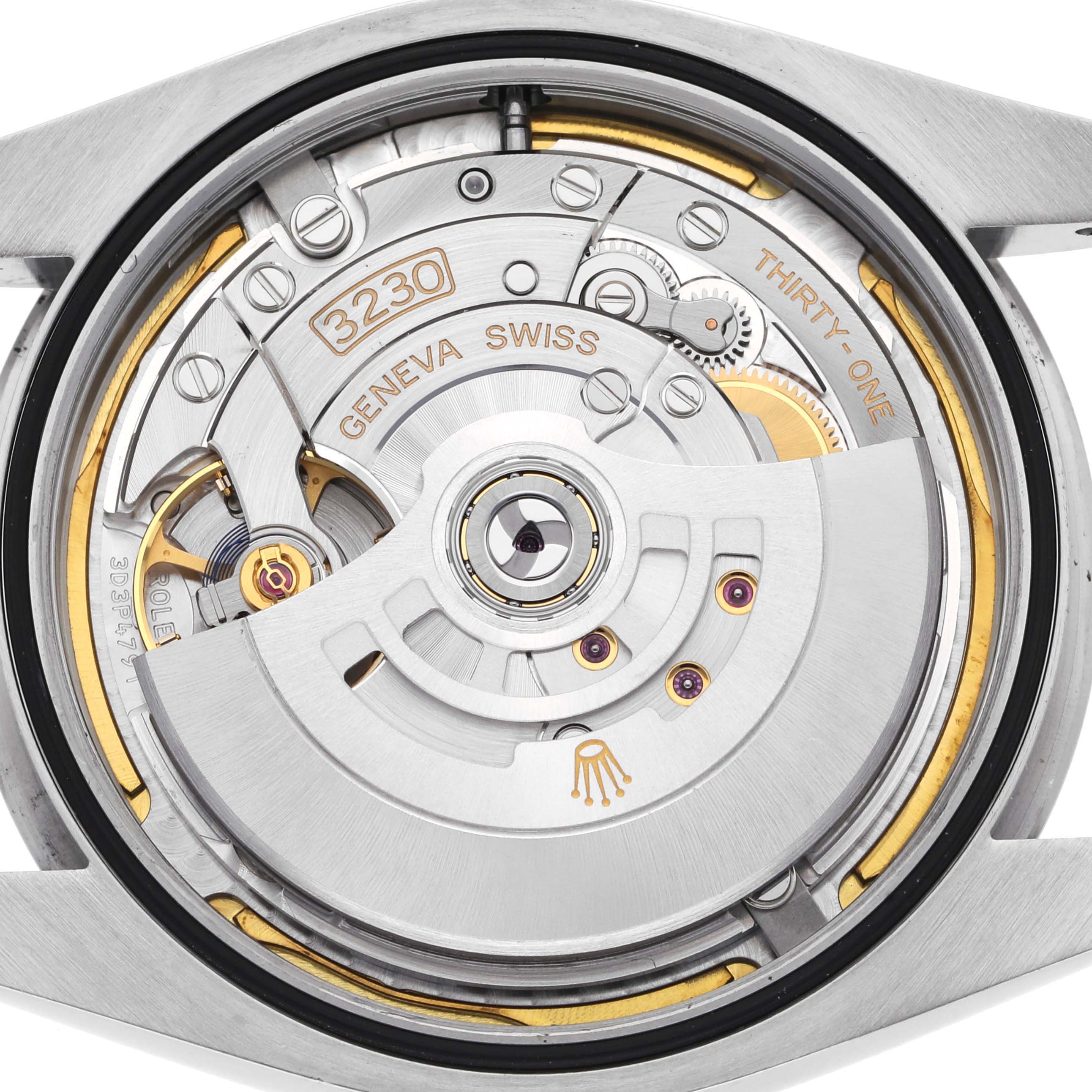 The image shows the Rolex Oyster Perpetual 124300 Men
s Stainless Steel Green Dial 124300 Men
s Stainless Steel Green Dial
s movement from a top-down angle, highlighting the rotor and mechanical components.