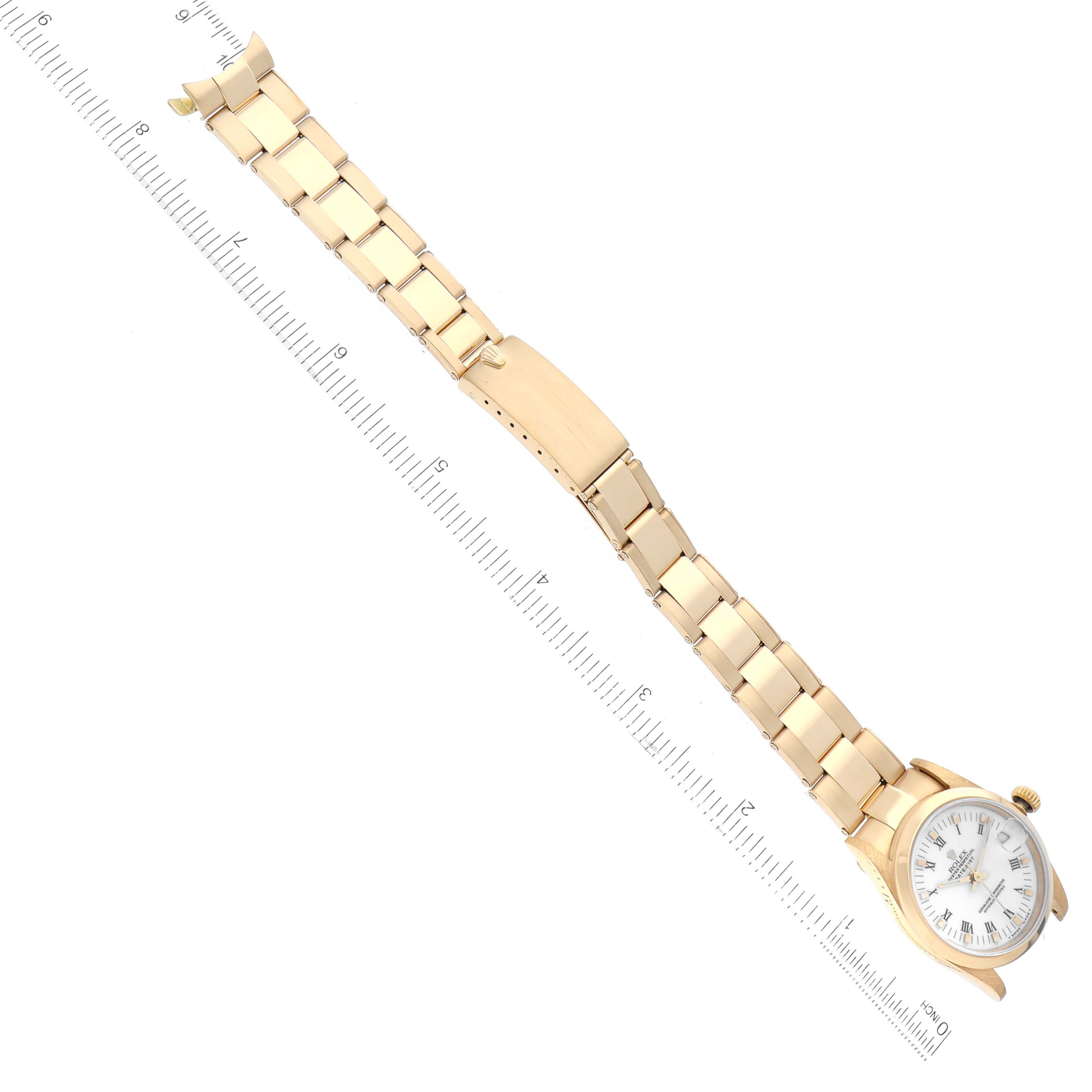 The image displays a Rolex President 68248 Women's Yellow Gold White Dial 68248 Women's Yellow Gold White Dial model watch laid flat with a gold bracelet, alongside a ruler for scale reference.