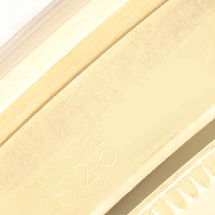 This close-up image of the Rolex President 68248 Women's Yellow Gold White Dial 68248 Women's Yellow Gold White Dial model shows the engraved surface with part of the serial number.