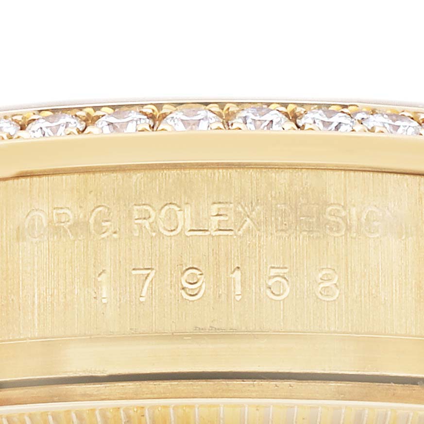 The image shows the side engraving of a Rolex President 179158 Women's Yellow Gold Champagne Dial 179158 Women's Yellow Gold Champagne Dial watch, highlighting the model number and diamond-set bezel.