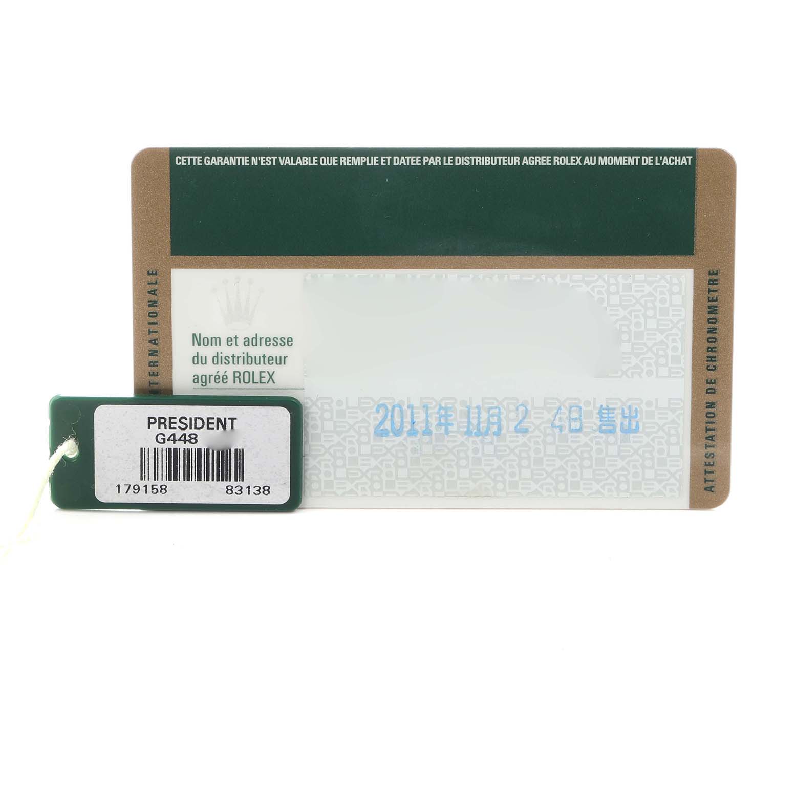 The image shows a warranty card and a tag for the Rolex President 179158 Women's Yellow Gold Champagne Dial 179158 Women's Yellow Gold Champagne Dial model from a top-down angle.