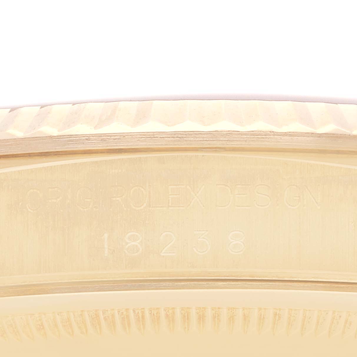 This image shows a close-up of the serial engraving and fluted bezel on a Rolex President 18238 Men's Yellow Gold Champagne Dial 18238 Men's Yellow Gold Champagne Dial model watch.