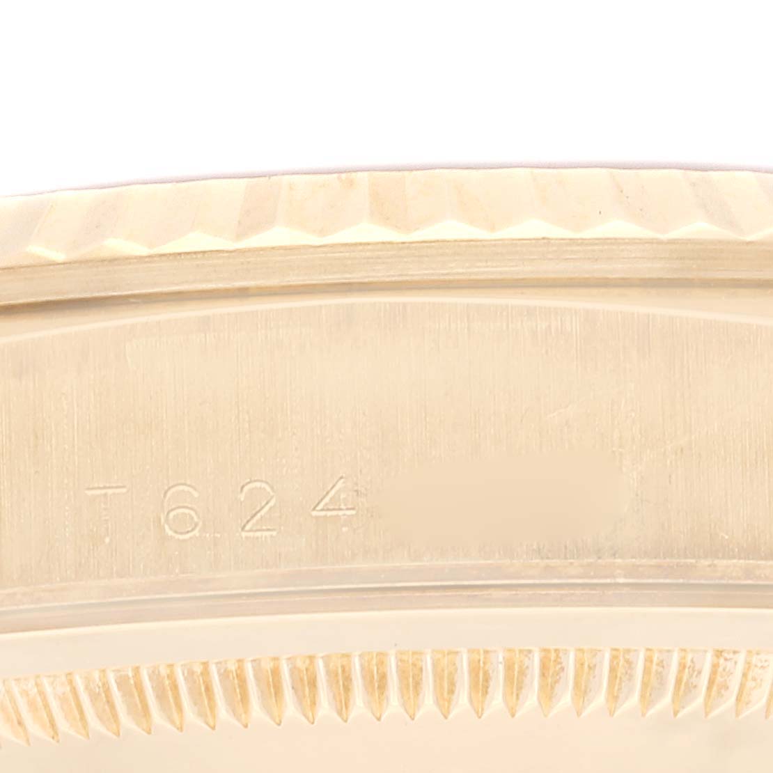 This image shows a close-up of the bezel and part of the case back of a Rolex President 18238 Men's Yellow Gold Champagne Dial 18238 Men's Yellow Gold Champagne Dial model watch.