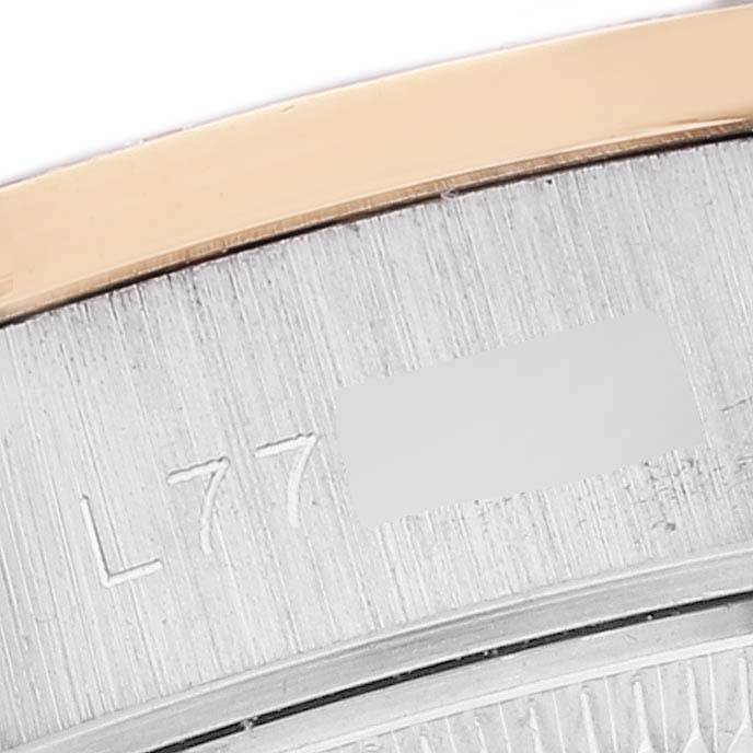 This image shows a close-up of the Rolex President 69139 Women's White Gold Brown Dial 69139 Women's White Gold Brown Dial model caseback, featuring engraved numbers and part of the bezel.