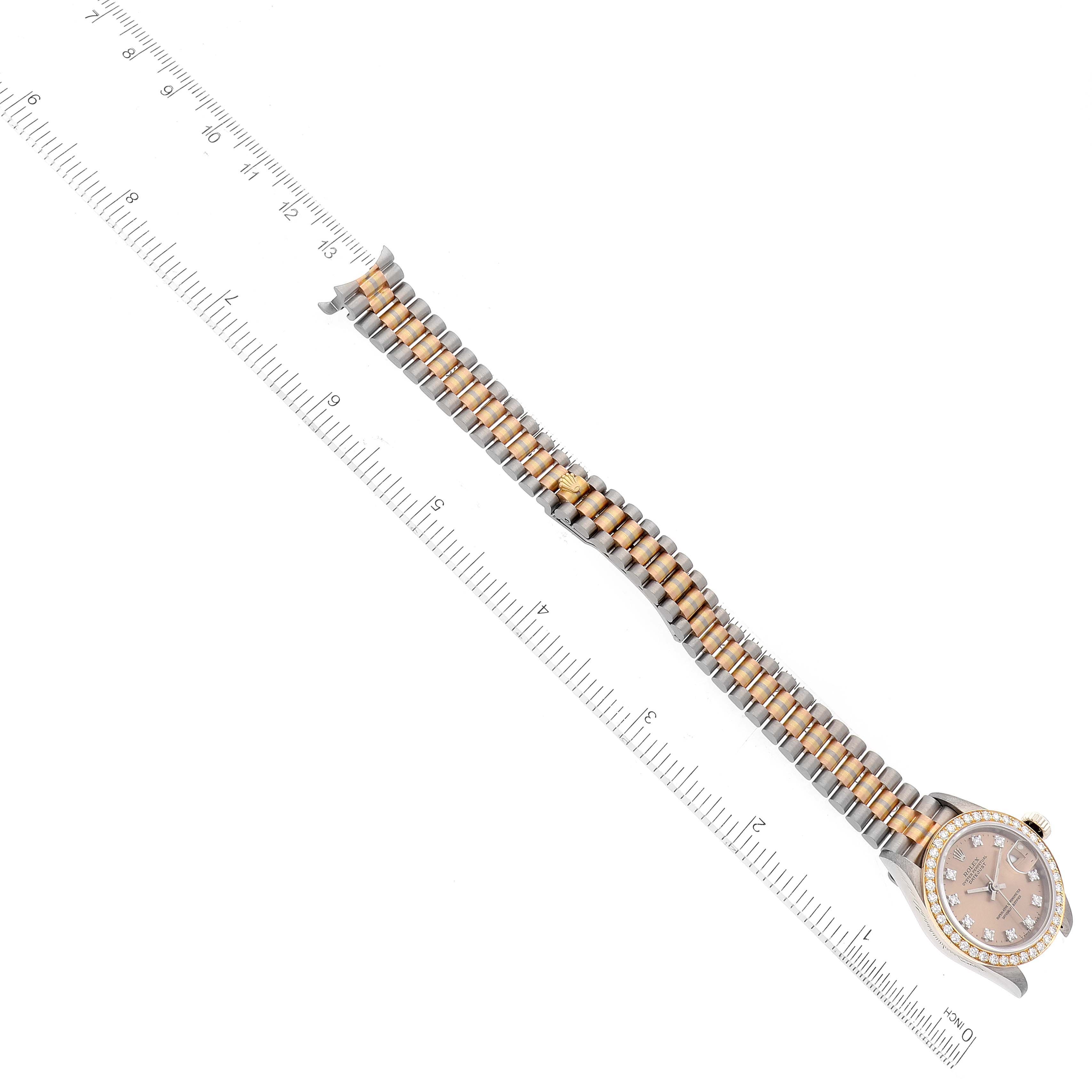 The Rolex President 69139 Women's White Gold Brown Dial 69139 Women's White Gold Brown Dial model watch is shown laid flat from a top-down angle, displaying the dial, bezel, and bracelet with a ruler for measurement.