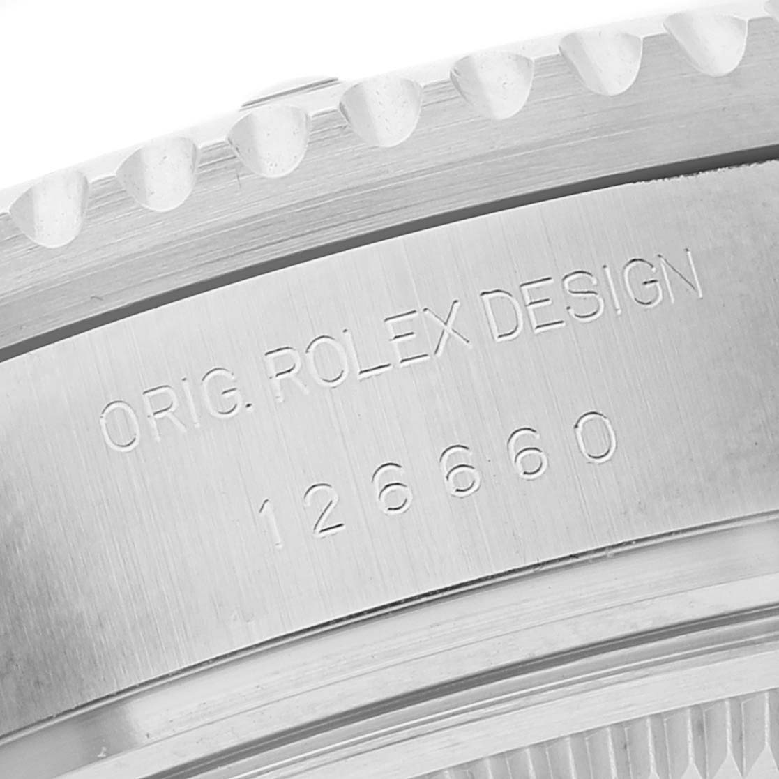 The image shows a close-up view of the serial number and design engraving on the side of a Rolex Sea-Dweller 126660 Men
s Stainless Steel Blue Dial 126660 Men
s Stainless Steel Blue Dial watch.