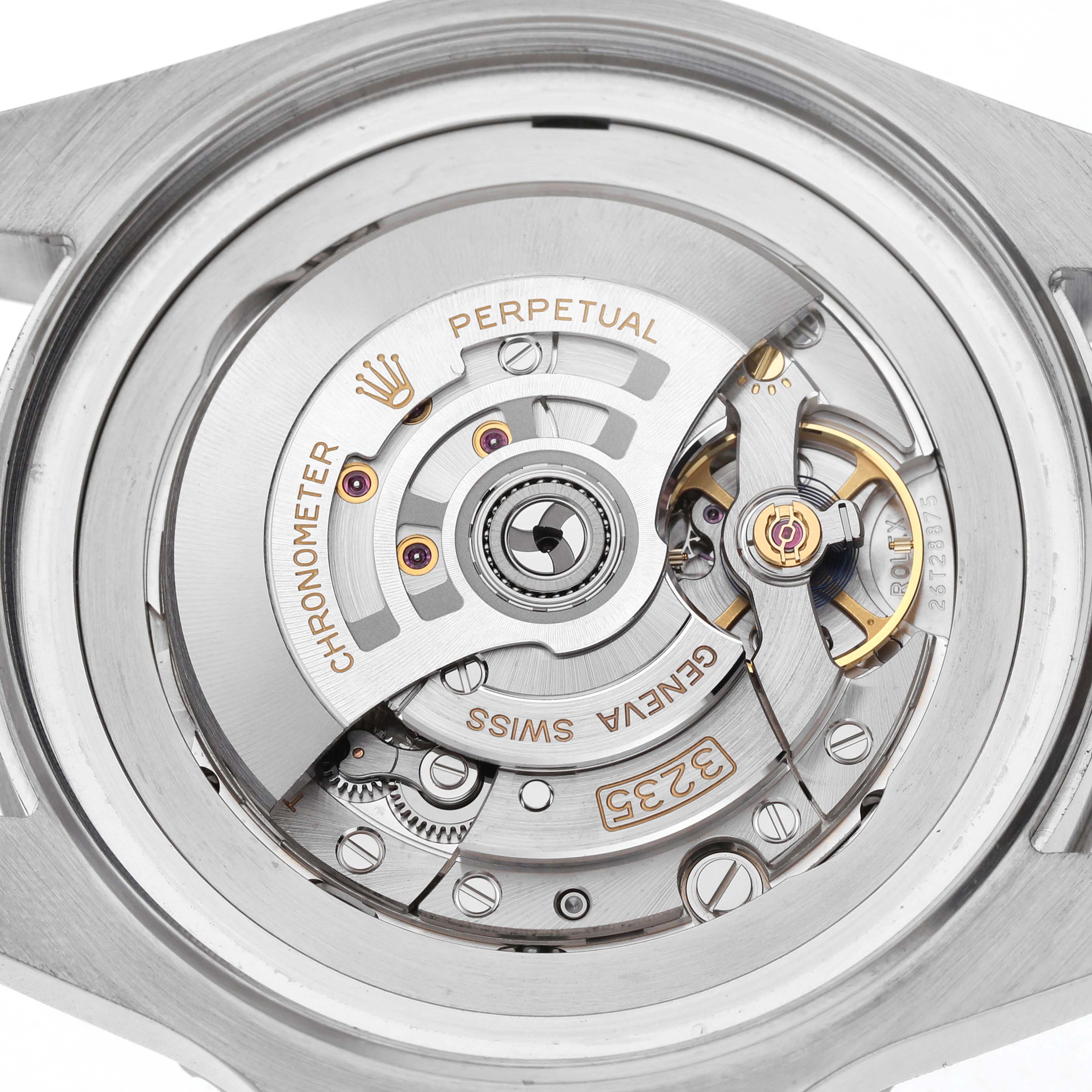The image shows a detailed view of the Rolex Sea-Dweller 126660 Men's Stainless Steel Blue Dial's movement, highlighting its gears and rotor.