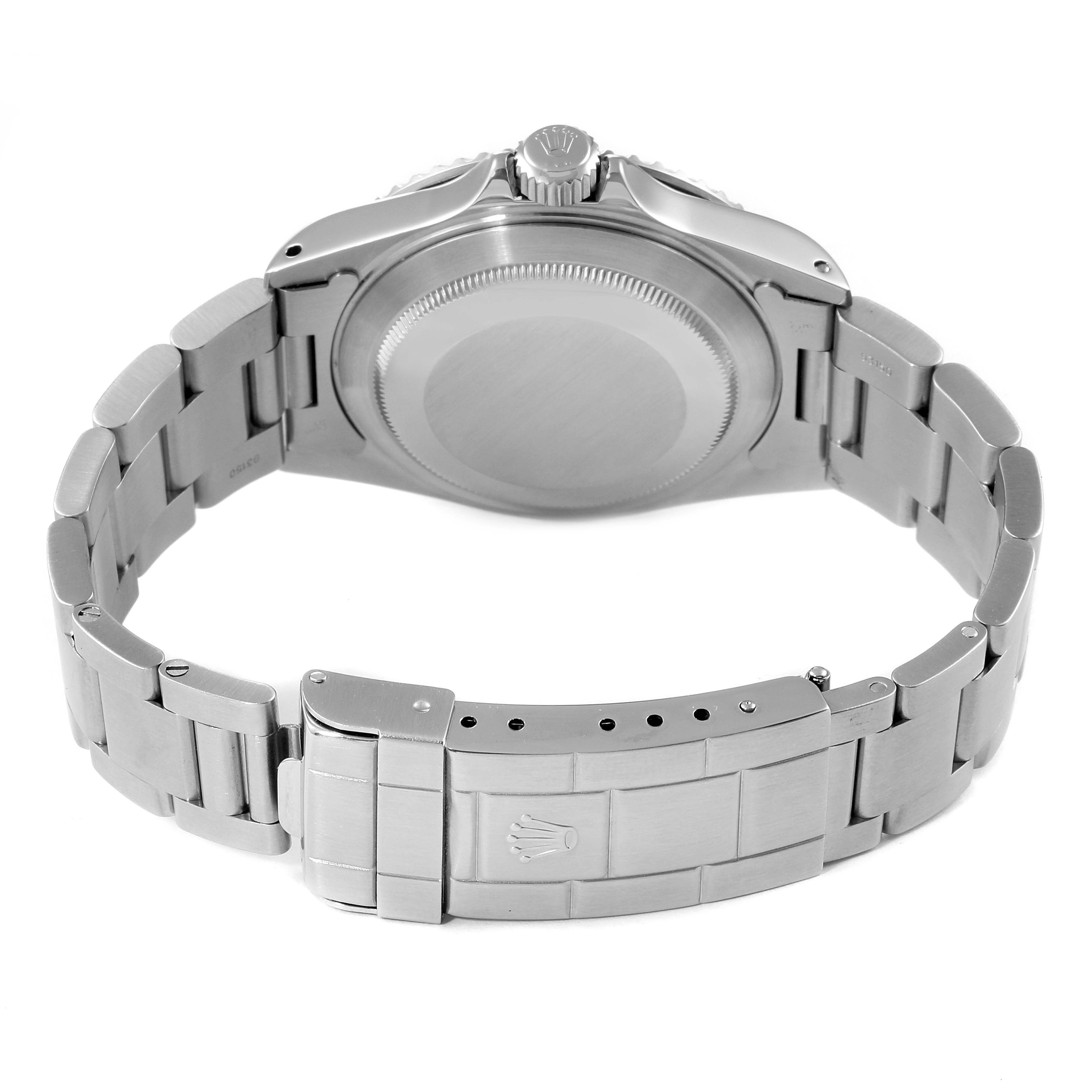 This image shows the backside of a Rolex Submariner 14060 Men
s Stainless Steel Black Dial 14060 Men
s Stainless Steel Black Dial watch including its case back, crown, and bracelet with clasp.