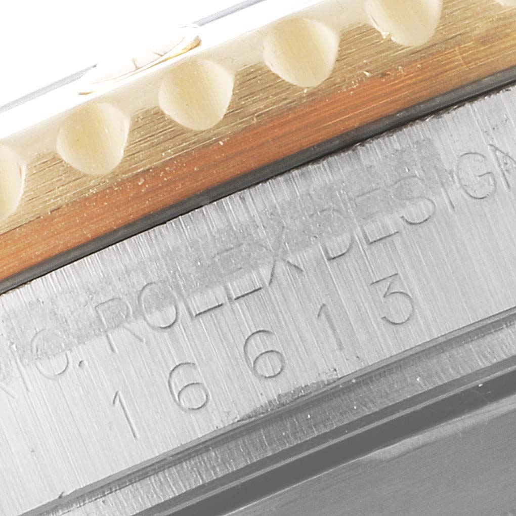 The image shows a close-up angle of the bezel and case of the Rolex Submariner 16613 Men's Steel and Gold (two tone) Blue Dial 16613 Men's Steel and Gold (two tone) Blue Dial 16613.