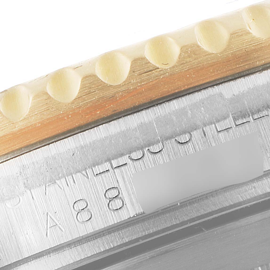 This close-up image shows the case edge and part of the bezel of a Rolex Submariner 16613 Men's Steel and Gold (two tone) Blue Dial 16613 Men's Steel and Gold (two tone) Blue Dial watch, revealing the engraved serial number.