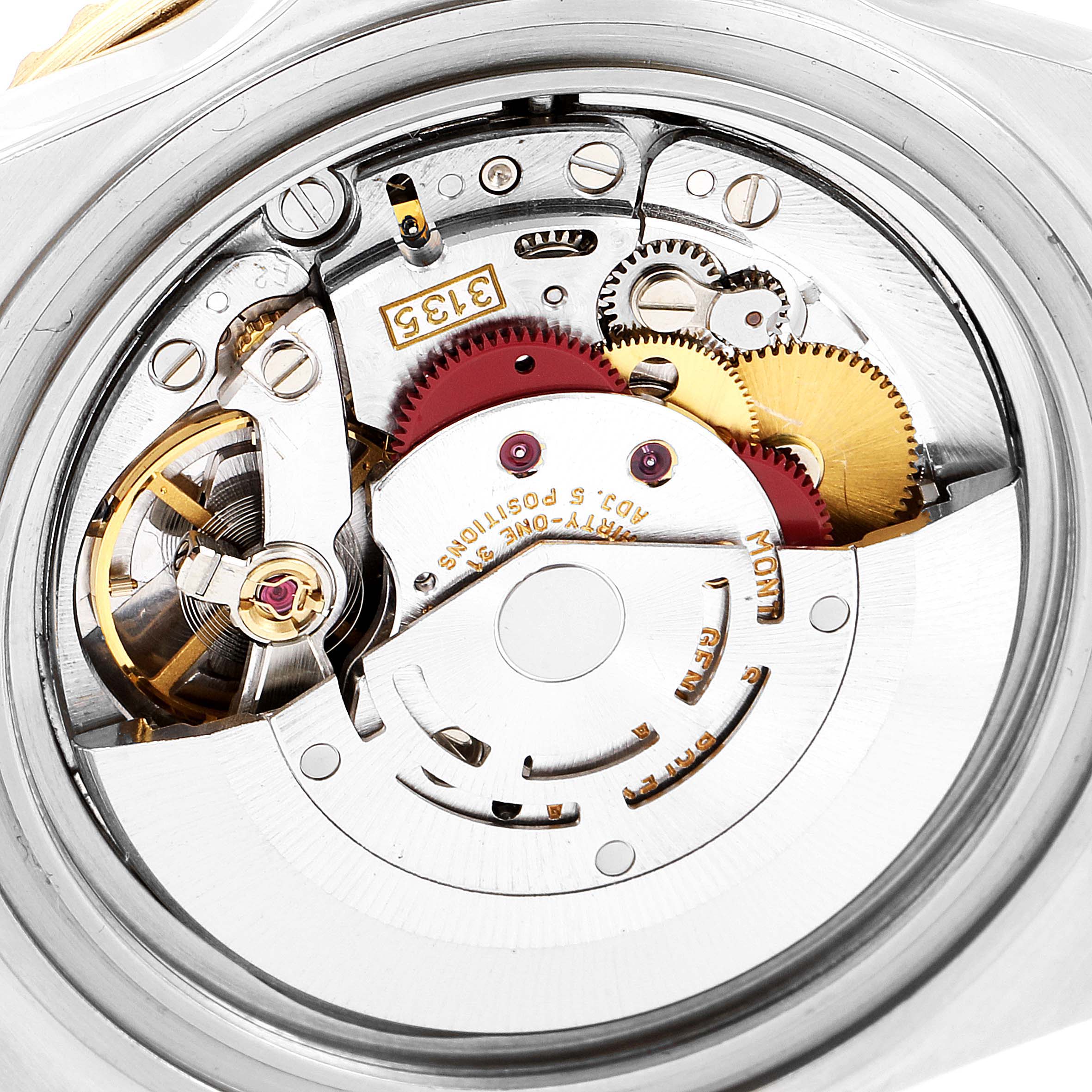 This image shows the inner mechanical movement of the Rolex Submariner 16613 Men's Steel and Gold (two tone) Blue Dial 16613 Men's Steel and Gold (two tone) Blue Dial, highlighting gears and intricate parts from a close-up angle.