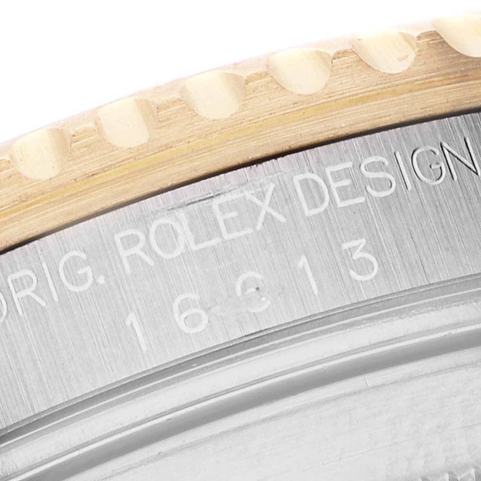 This close-up image shows the engraved bezel and case of a Rolex Submariner 16613 Men's Steel and Gold (two tone) Blue Dial 16613 Men's Steel and Gold (two tone) Blue Dial watch.