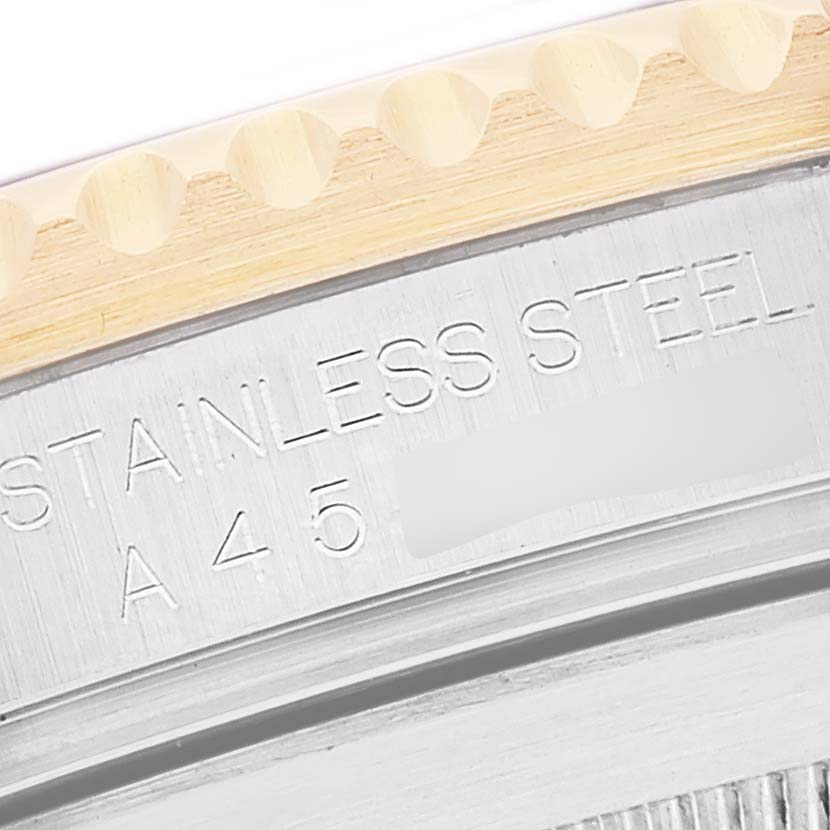 This close-up image of the Rolex Submariner 16613 Men's Steel and Gold (two tone) Blue Dial 16613 Men's Steel and Gold (two tone) Blue Dial watch shows part of its stainless steel back case and engraved writing.