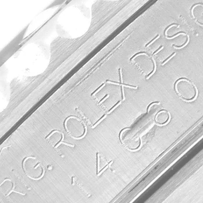 This close-up image shows an engraved part of the Rolex Submariner 14060 Men
s Stainless Steel Black Dial 14060 Men
s Stainless Steel Black Dial watch, focusing on the branding and markings.