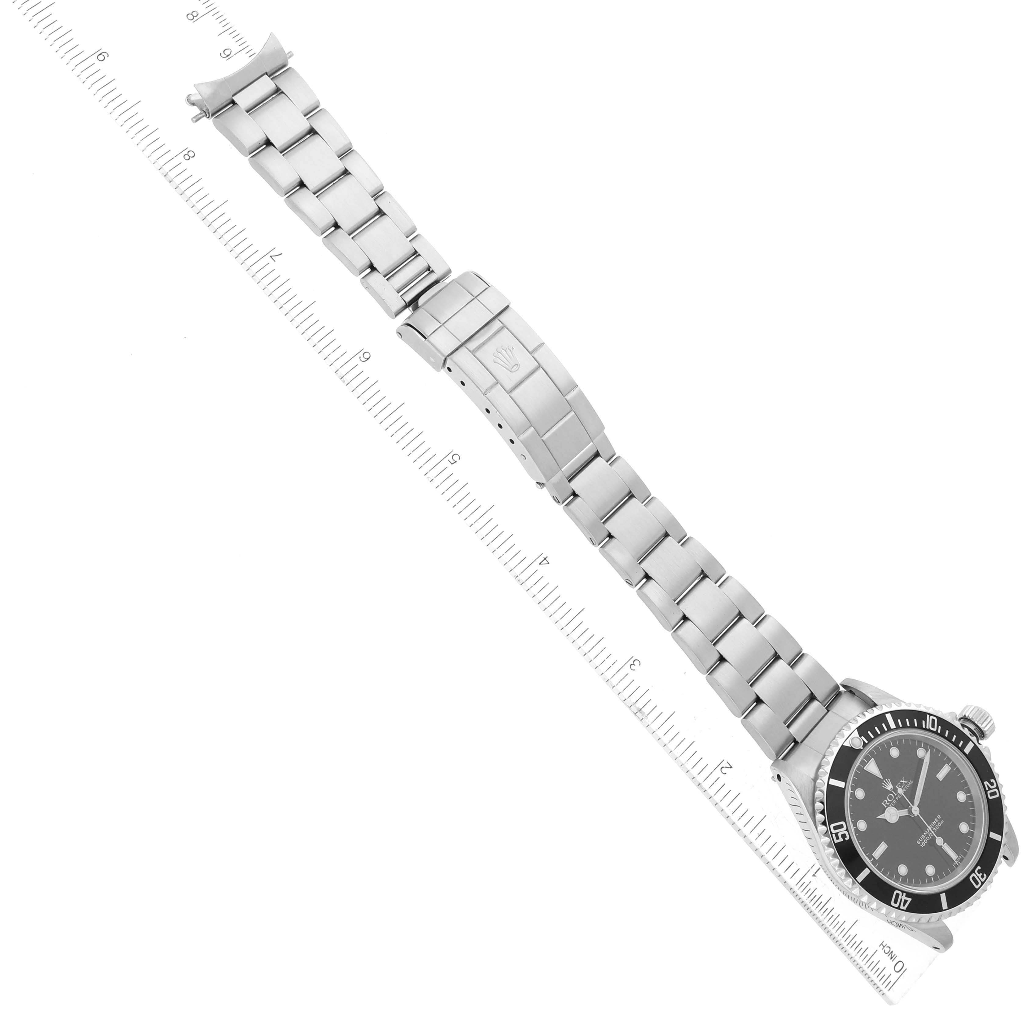This image shows a top-down view of a Rolex Submariner 14060 Men
s Stainless Steel Black Dial 14060 Men
s Stainless Steel Black Dial watch, focusing on the entire length of the watch and bracelet, with a ruler for scale.