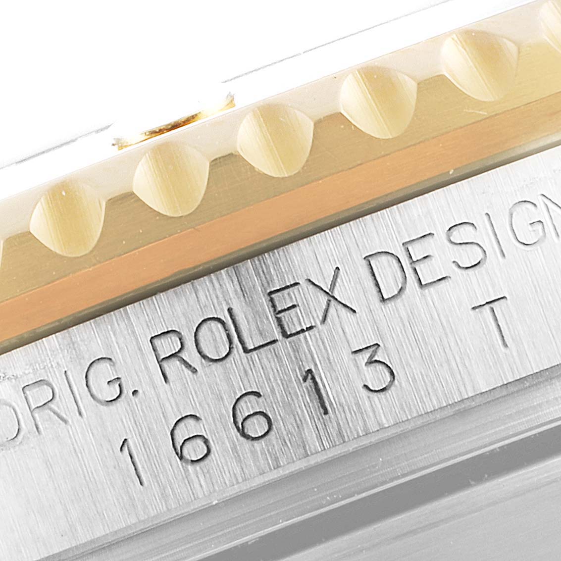 Close-up of the side engraving and the edge of the bezel on a Rolex Submariner 16613 Men
s Steel and Gold (two tone) Blue Dial 16613 Men
s Steel and Gold (two tone) Blue Dial model watch.