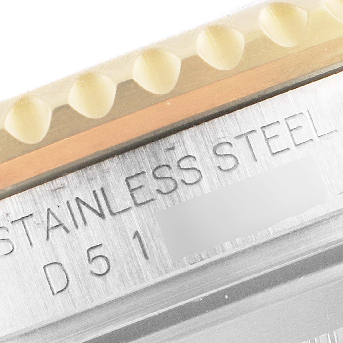 This image shows a close-up of the material and serial engraving on the side of the Rolex Submariner 16613 Men
s Steel and Gold (two tone) Blue Dial 16613 Men
s Steel and Gold (two tone) Blue Dial watch.