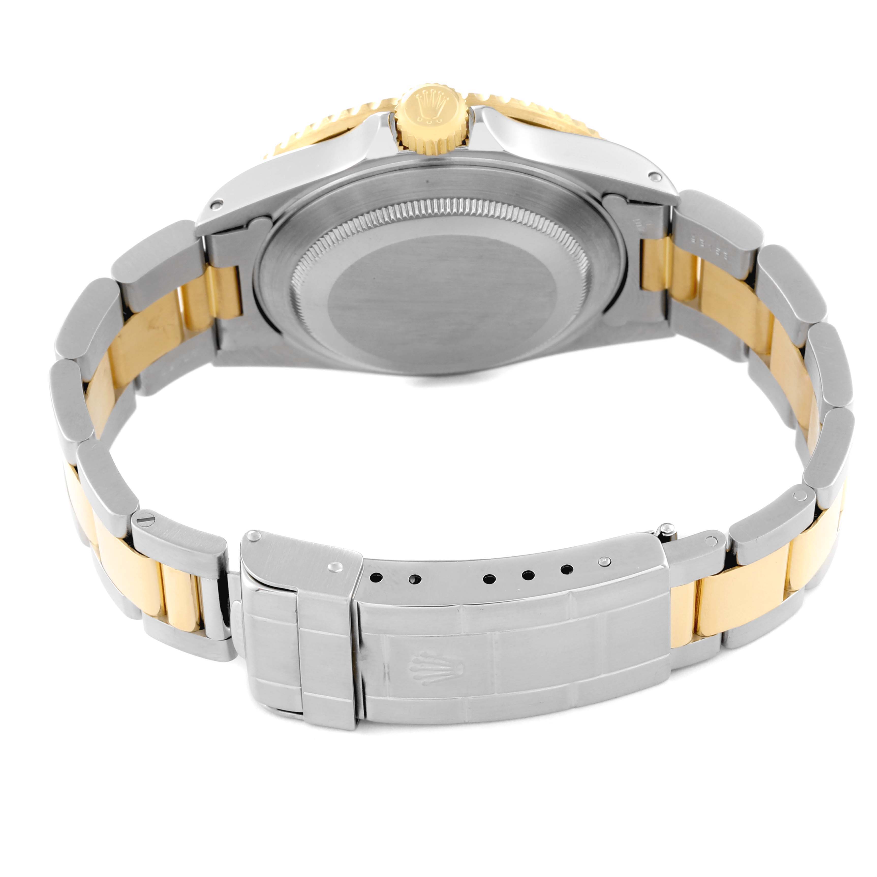 The image shows the back view of a Rolex Submariner 16613 Men's Steel and Gold (two tone) Silver Dial 16613 Men's Steel and Gold (two tone) Silver Dial watch, highlighting its case back, crown, and two-tone oyster bracelet.