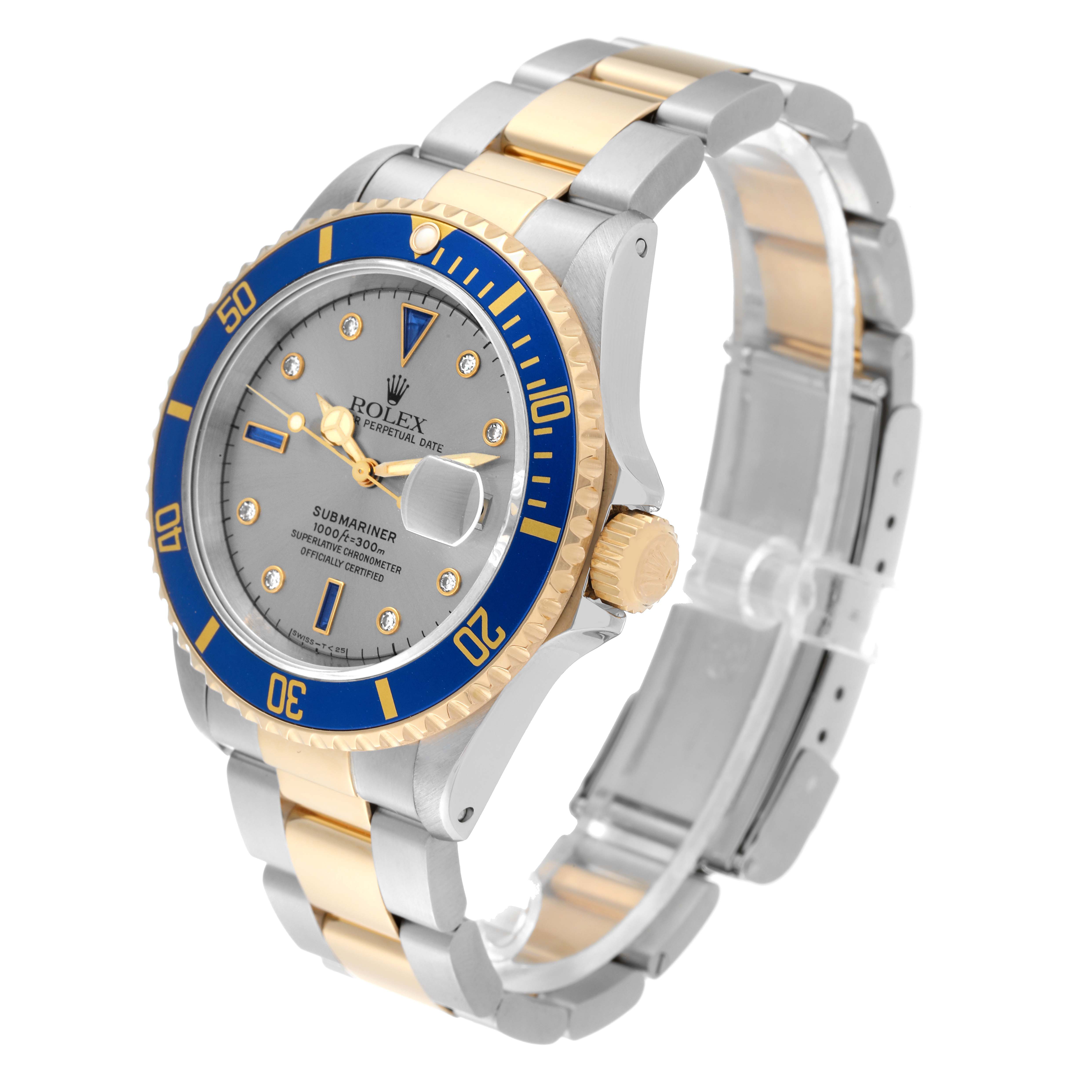 The image shows a Rolex Submariner 16613 Men's Steel and Gold (two tone) Silver Dial 16613 Men's Steel and Gold (two tone) Silver Dial watch at an angled view, highlighting its blue bezel, gold accents, and two-tone bracelet.