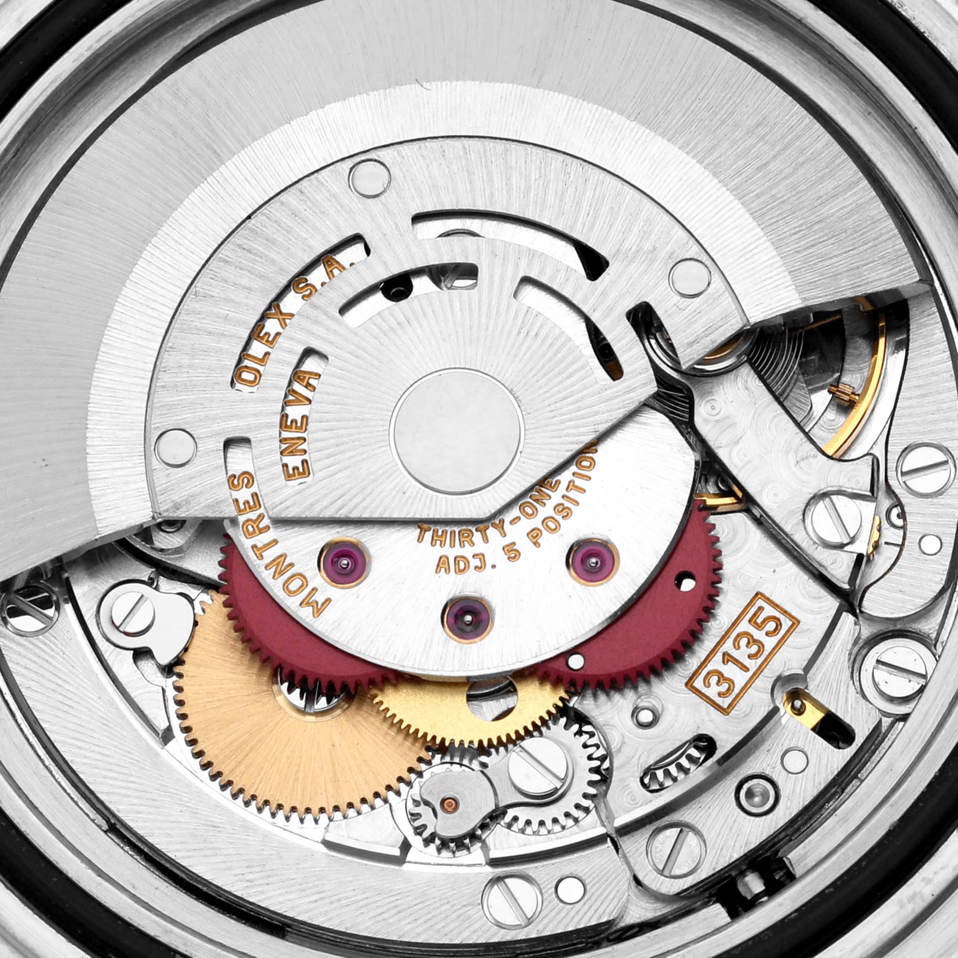 This close-up image shows the intricate movement mechanism of a Rolex Submariner 16613 Men's Steel and Gold (two tone) Silver Dial 16613 Men's Steel and Gold (two tone) Silver Dial watch, displaying various gears and engravings.