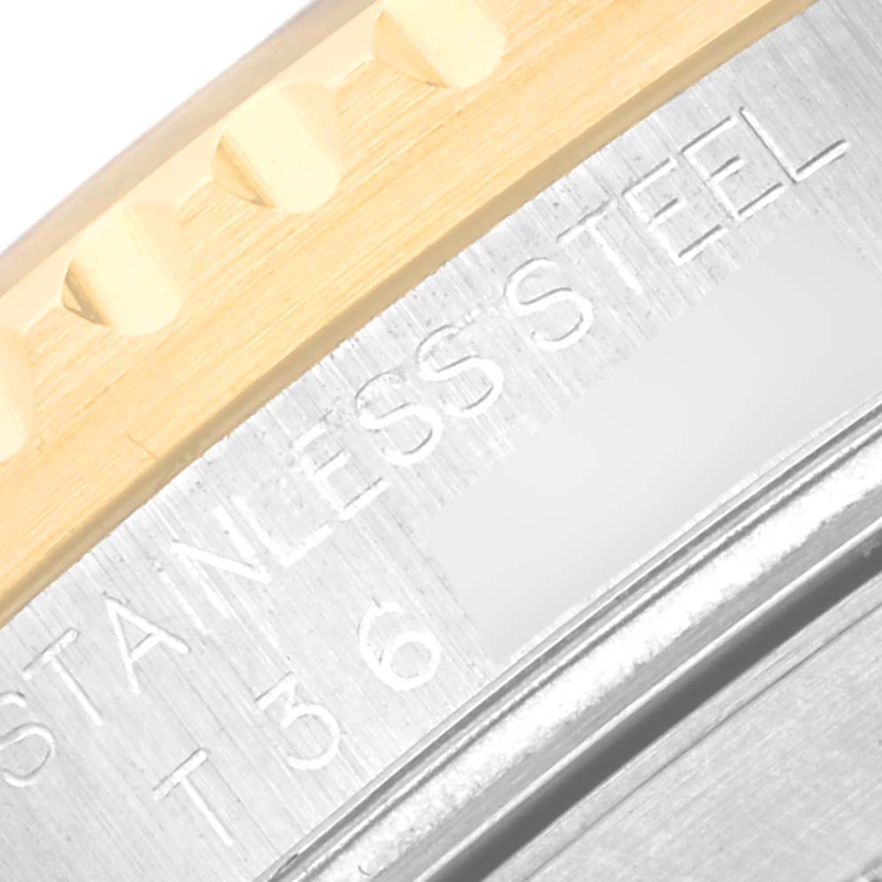 The image shows a close-up of the bezel and case of the Rolex Submariner 16613 Men's Steel and Gold (two tone) Silver Dial 16613 Men's Steel and Gold (two tone) Silver Dial, emphasizing the materials and "STAINLESS STEEL" engraving.