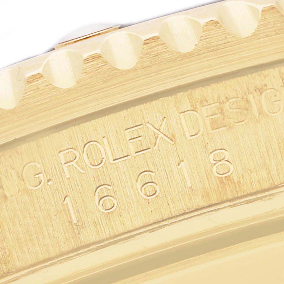 This close-up image shows the side case and bezel of a Rolex Submariner 16618 Men's Yellow Gold Blue Dial 16618 Men's Yellow Gold Blue Dial, detailing the engraved model number 16618.
