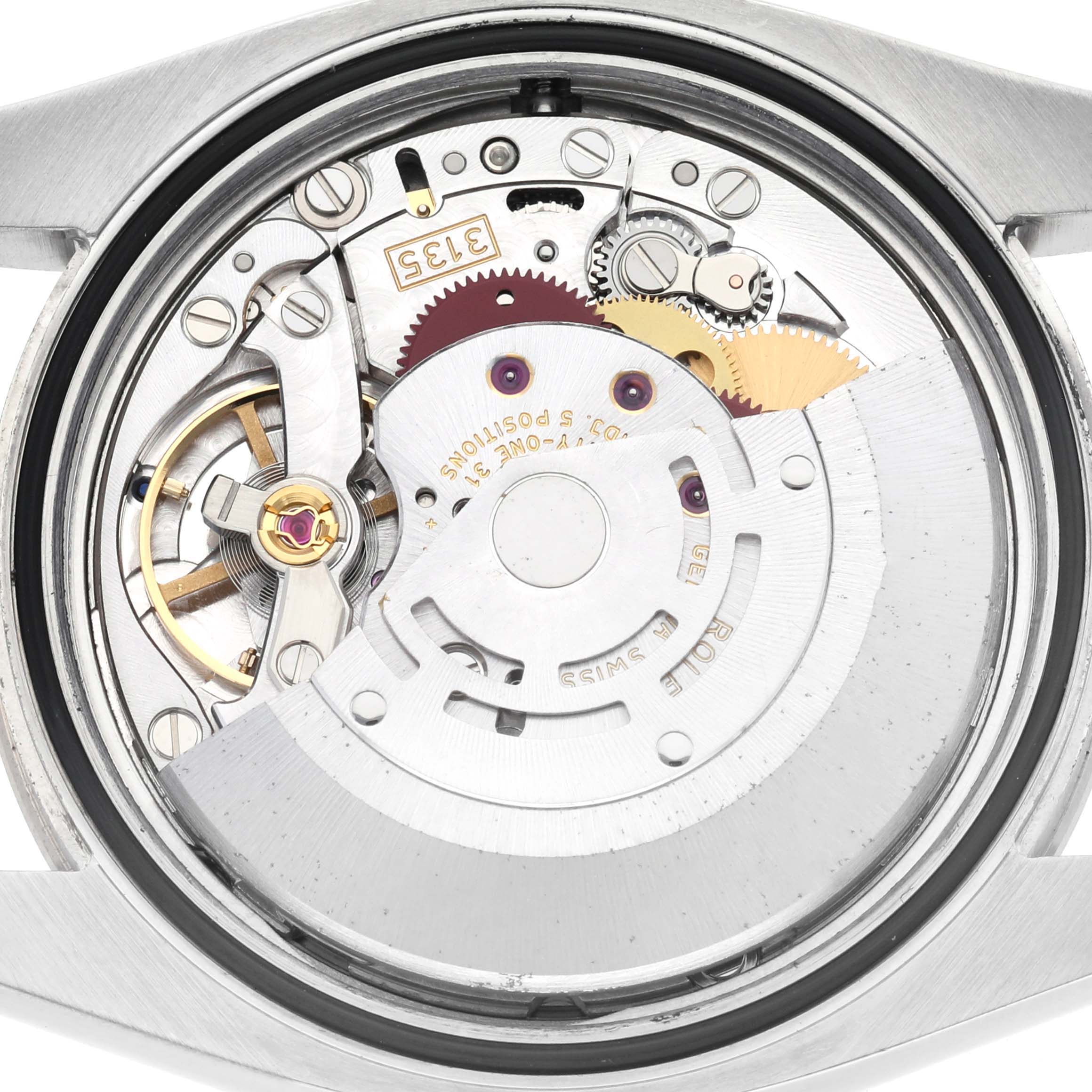 The image shows a Rolex Turn-o-Graph 116264 Men
s Stainless Steel Black Dial 116264 Men
s Stainless Steel Black Dial watch movement from the back, featuring gears and the rotor.