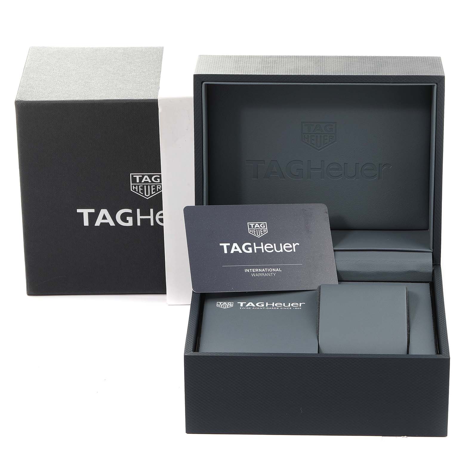 The image shows the packaging box and warranty card for a Tag Heuer Carrera CBG2A11.FC6460 Men's Stainless Steel Blue Dial CBG2A11.FC6460 Men's Stainless Steel Blue Dial watch, viewed from the front angle.