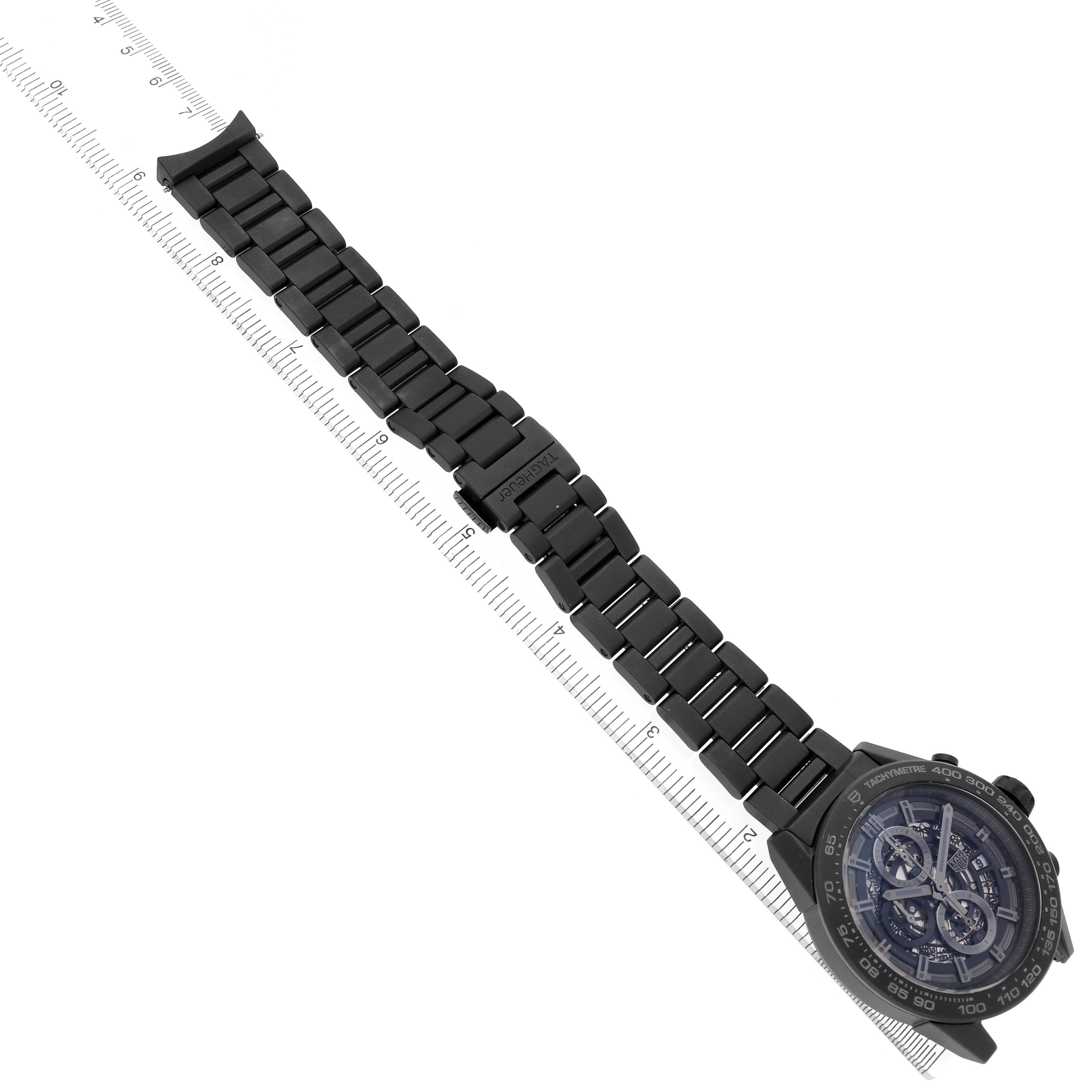 The Tag Heuer Carrera CAR2A91.BH0742 Men's Ceramic Black Dial watch is shown at an angle with emphasis on the face and full metal bracelet, measured against a ruler.