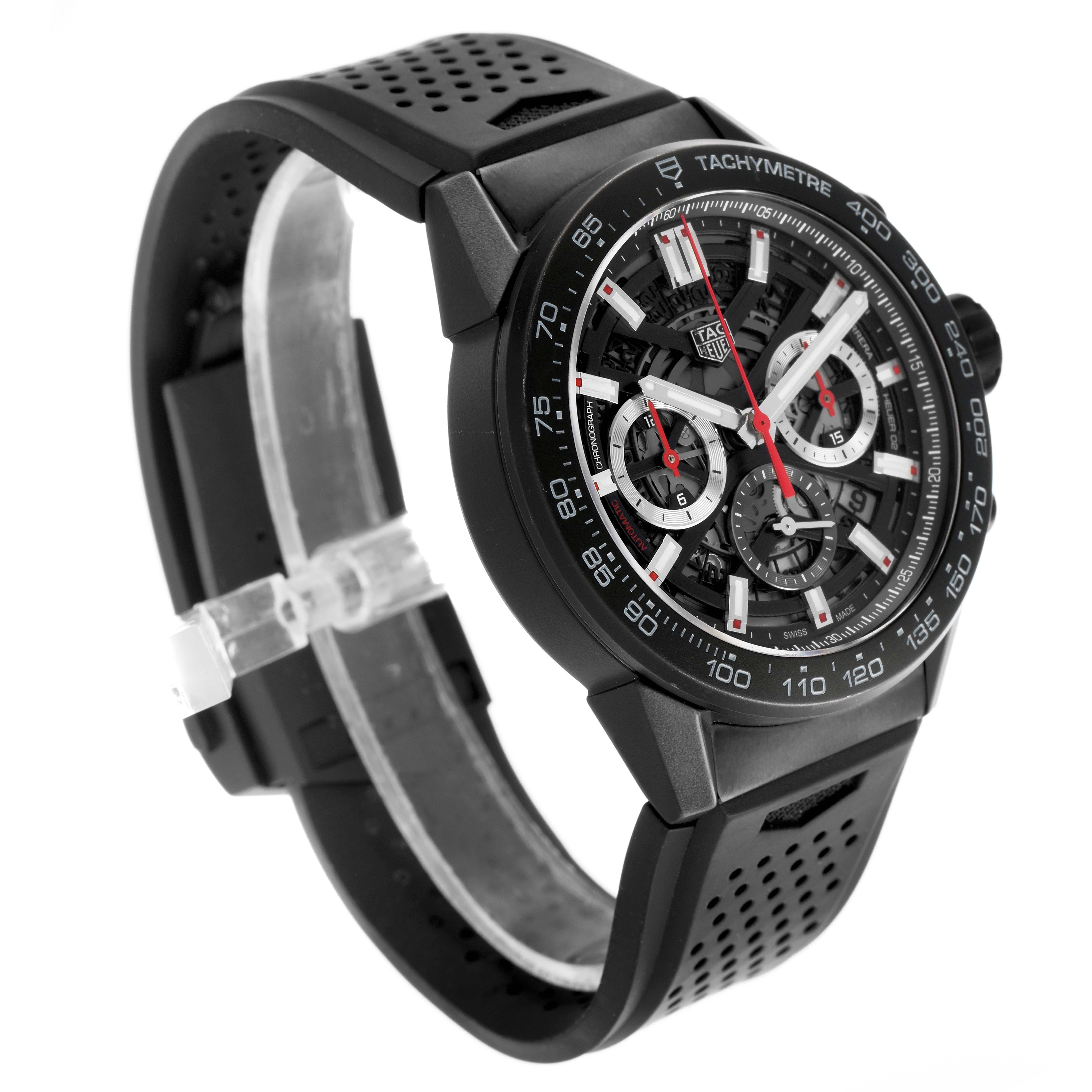 The Tag Heuer Carrera CBG2A90.BH0653 Men's Ceramic Black Dial watch is shown at an angled side view, featuring its dial, tachymeter, and perforated rubber strap.