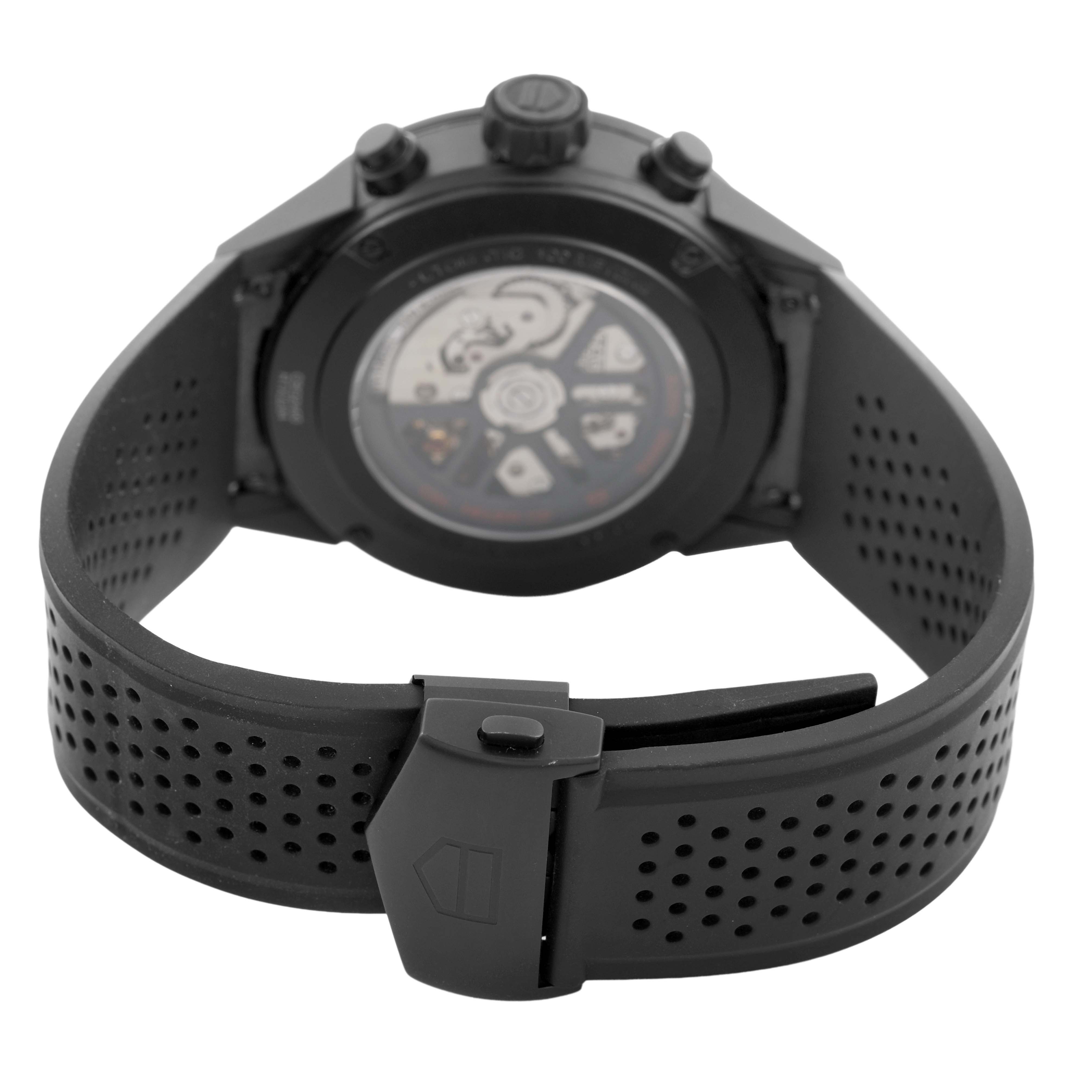 The image shows the back view of a Tag Heuer Carrera CBG2A90.BH0653 Men's Ceramic Black Dial, highlighting the exhibition case back and perforated strap with clasp.