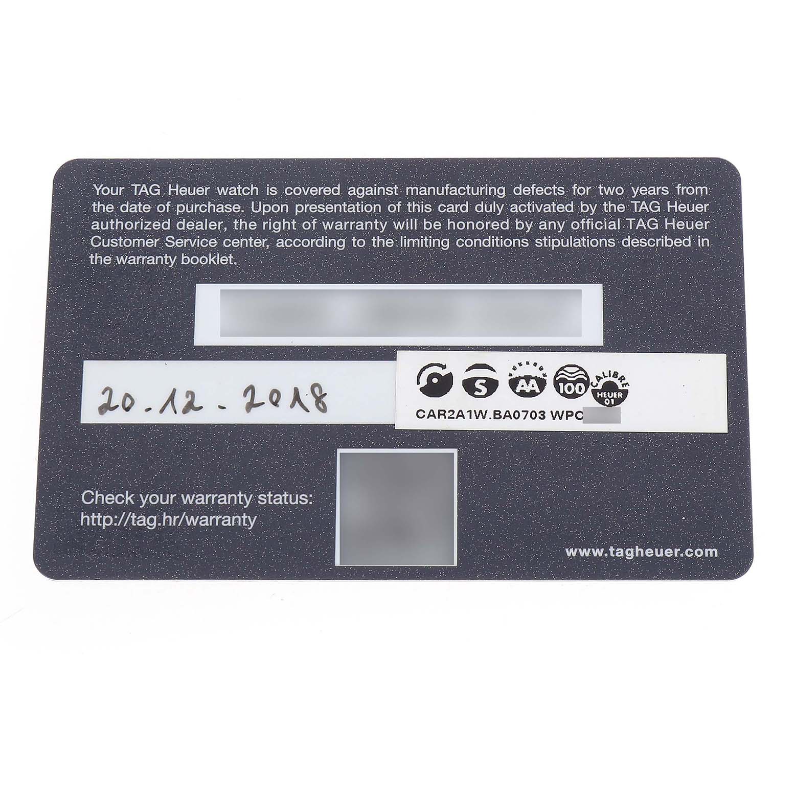The image shows a warranty card for the Tag Heuer Carrera CAR2A1W.BA0703 Men's Stainless Steel Transparent Dial model, featuring text and date information.