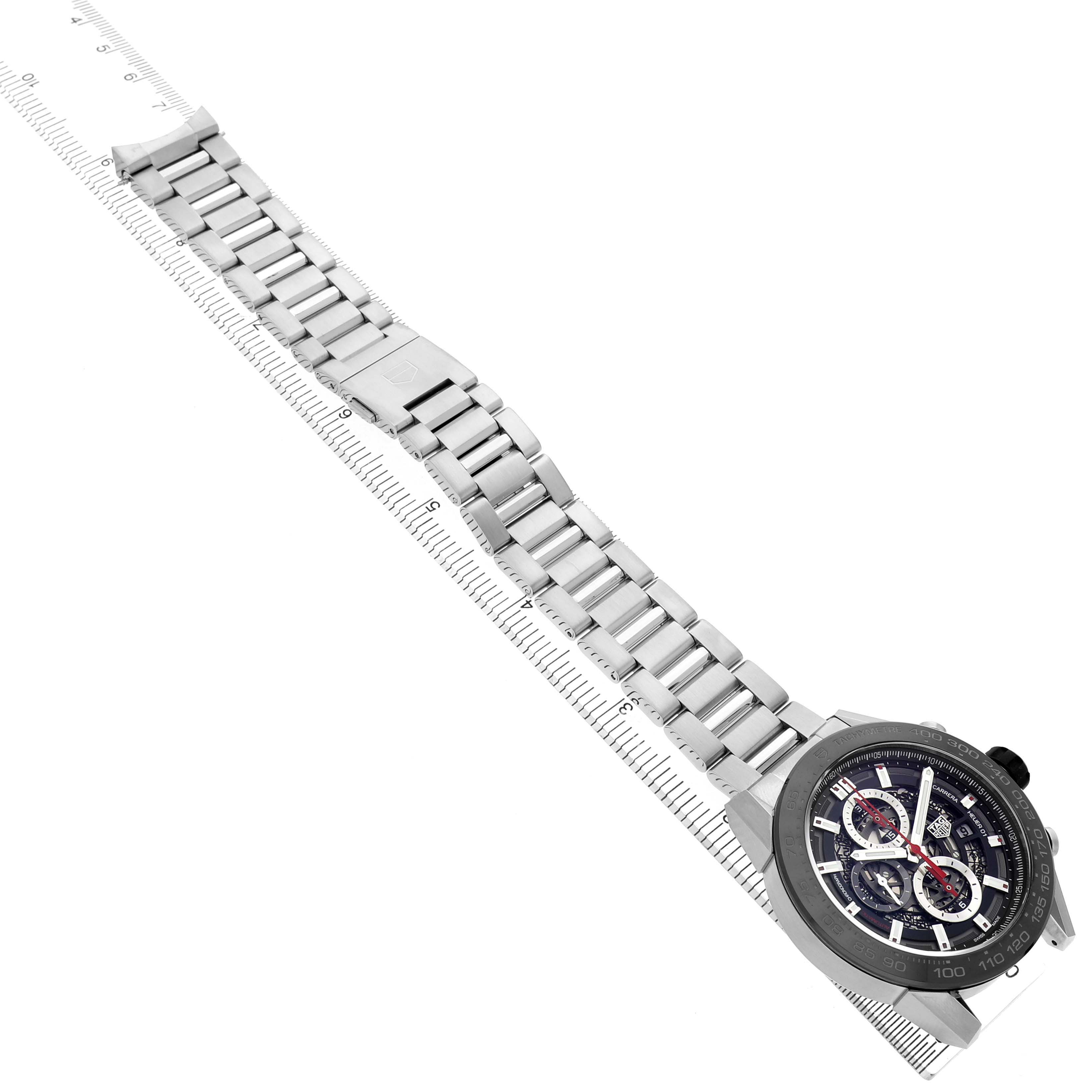 The image shows the Tag Heuer Carrera CAR2A1W.BA0703 Men's Stainless Steel Transparent Dial watch at an angled top view, highlighting its strap and face.