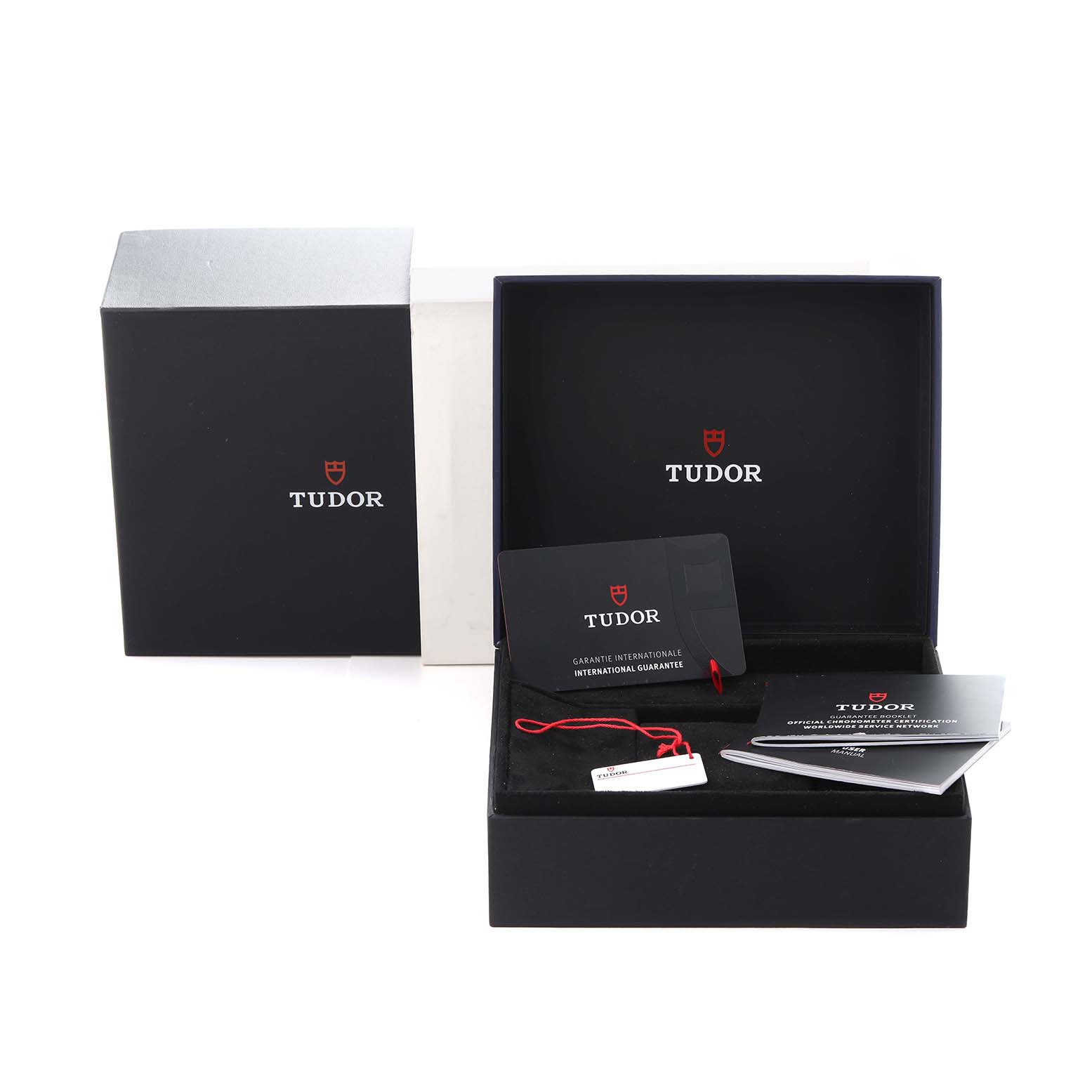 The image shows the packaging and accessories for a Tudor Pelagos M25707KN-0001 Men
s Stainless Steel Blue Dial M25707KN-0001 Men
s Stainless Steel Blue Dial watch, including a box, warranty card, and manuals.