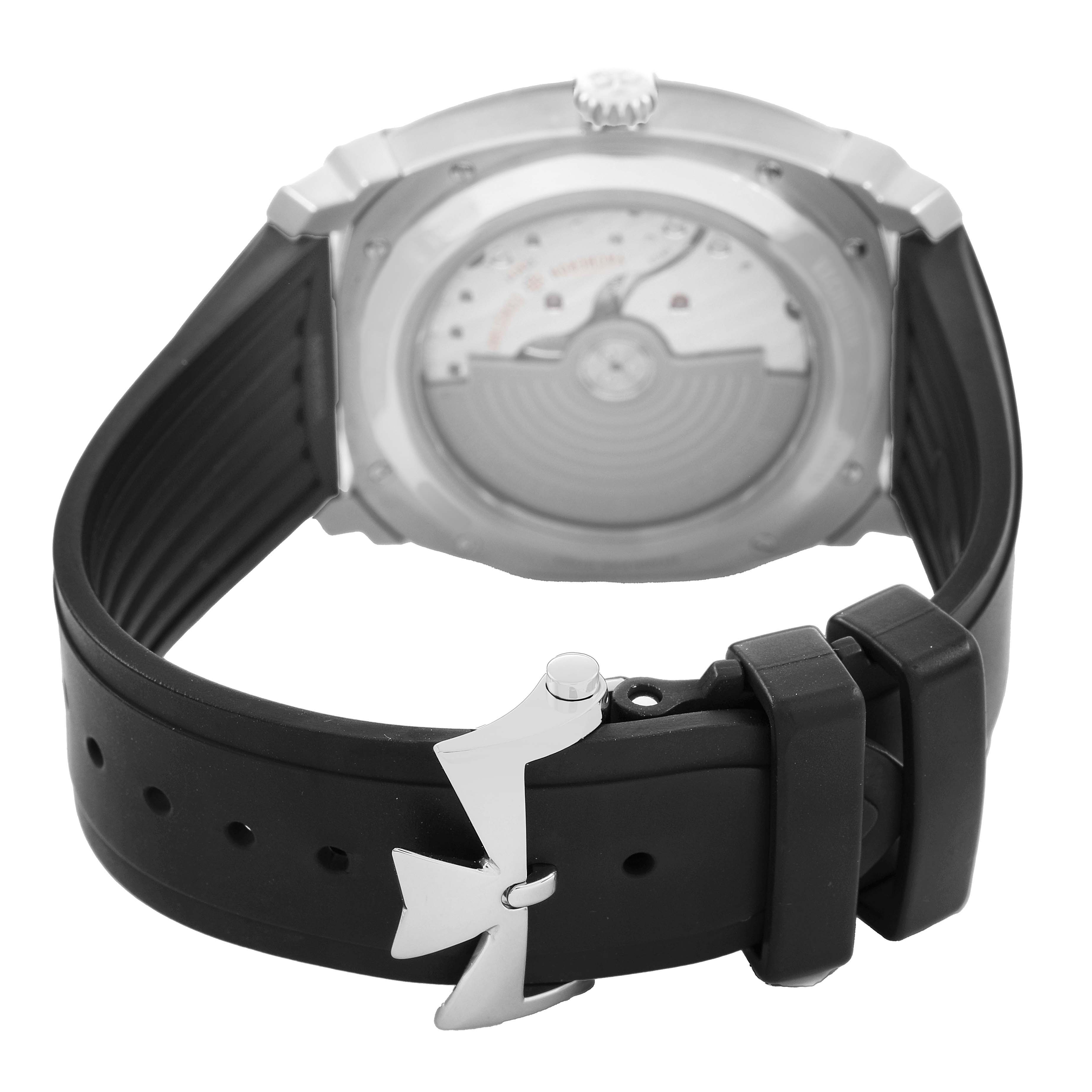 The image shows the back of a Vacheron Constantin Quai de l'Ile watch, highlighting the rotor and rubber strap with clasp.