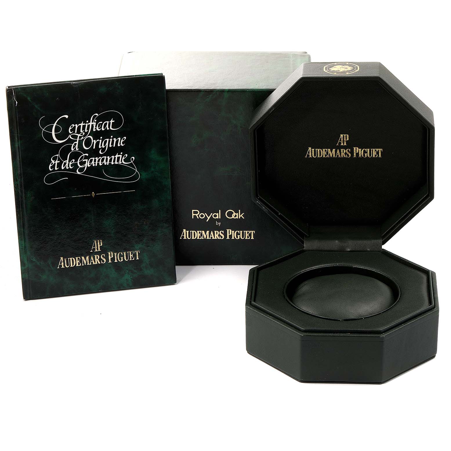 The image shows the packaging, warranty certificate, and display box for a Royal Oak model by Audemars Piguet.