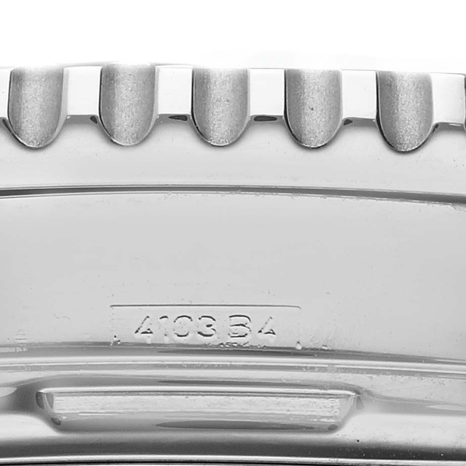 The image shows a close-up of the bezel edge and the side of a Breitling Navitimer A23322 Men
s Stainless Steel Blue Dial A23322 Men
s Stainless Steel Blue Dial watch, displaying the model number 4103 B4.