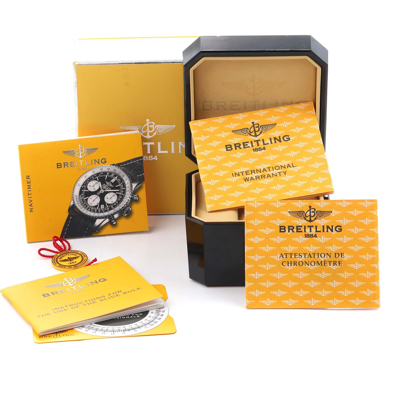 The image shows a Breitling Navitimer A23322 Men
s Stainless Steel Blue Dial A23322 Men
s Stainless Steel Blue Dial watch box, warranty cards, certificates, and a manual displayed at an angle.